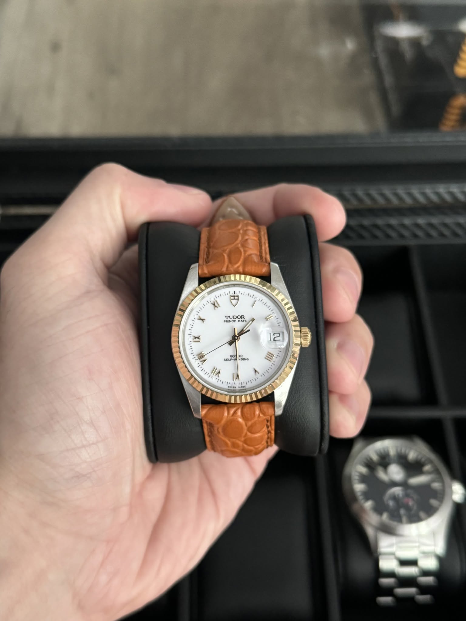 May be an image of wrist watch, leather, strap and text