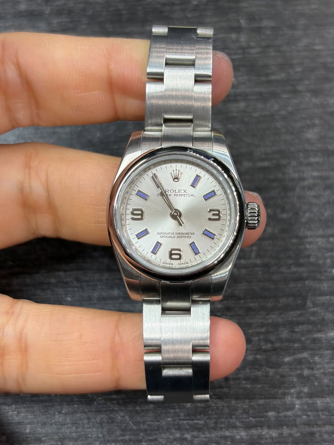 May be an image of wrist watch and text