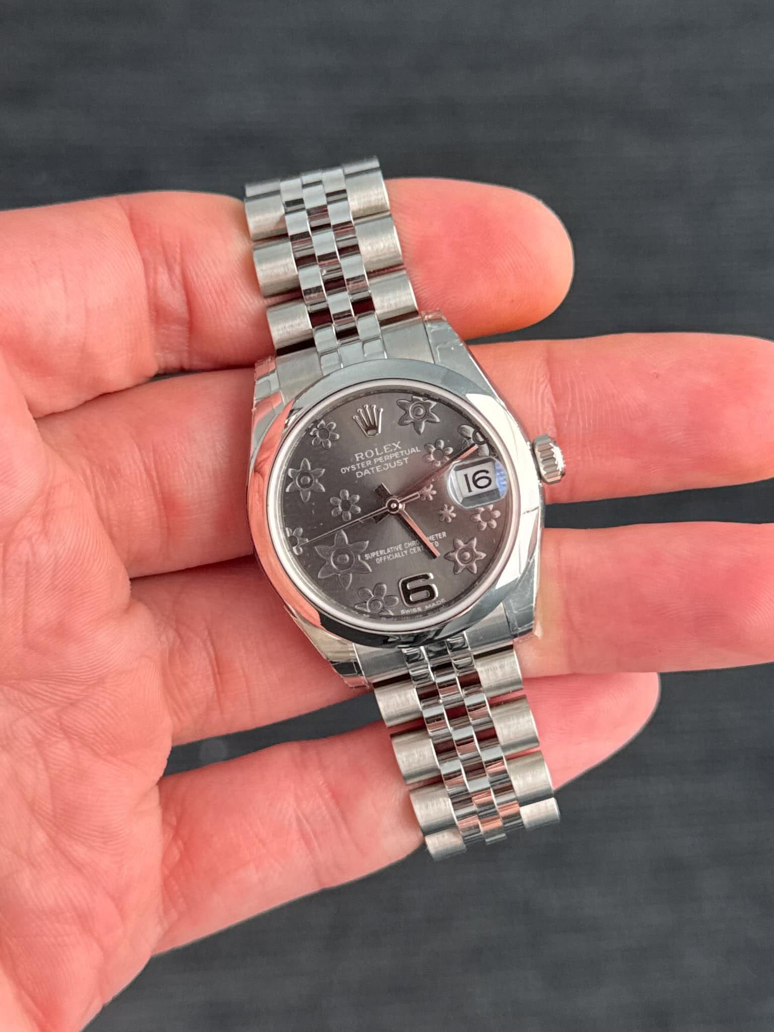 May be an image of wrist watch and text