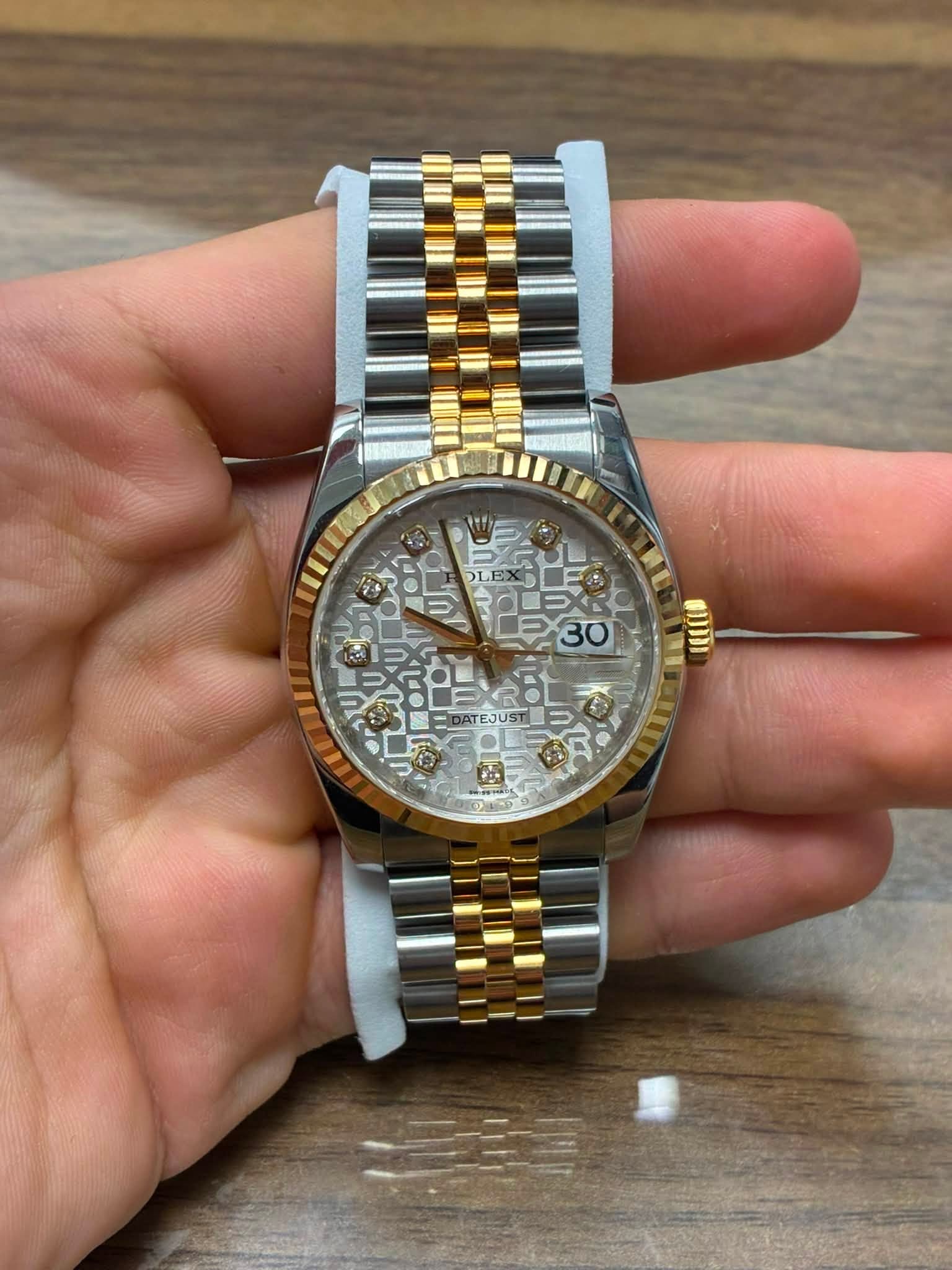 May be an image of wrist watch and text