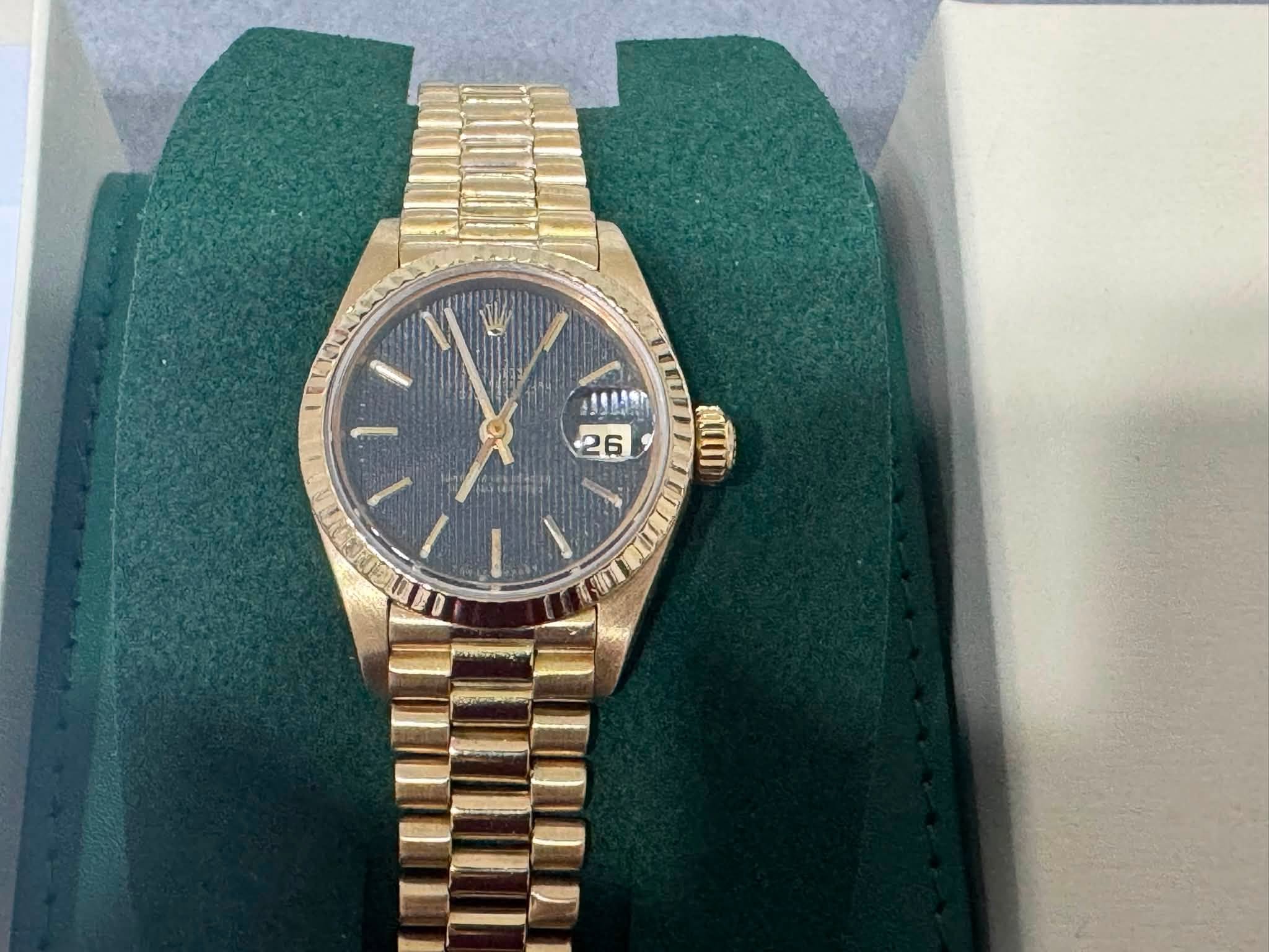 May be an image of wrist watch and text