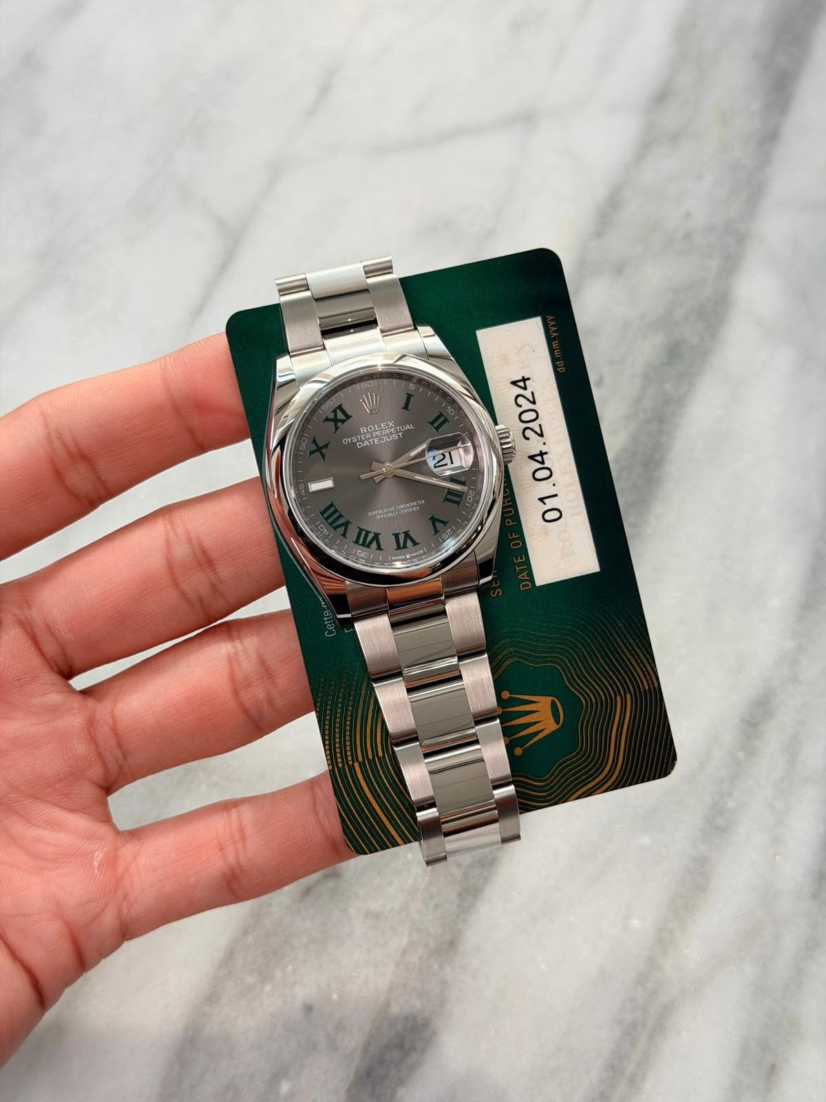 May be an image of wrist watch and text
