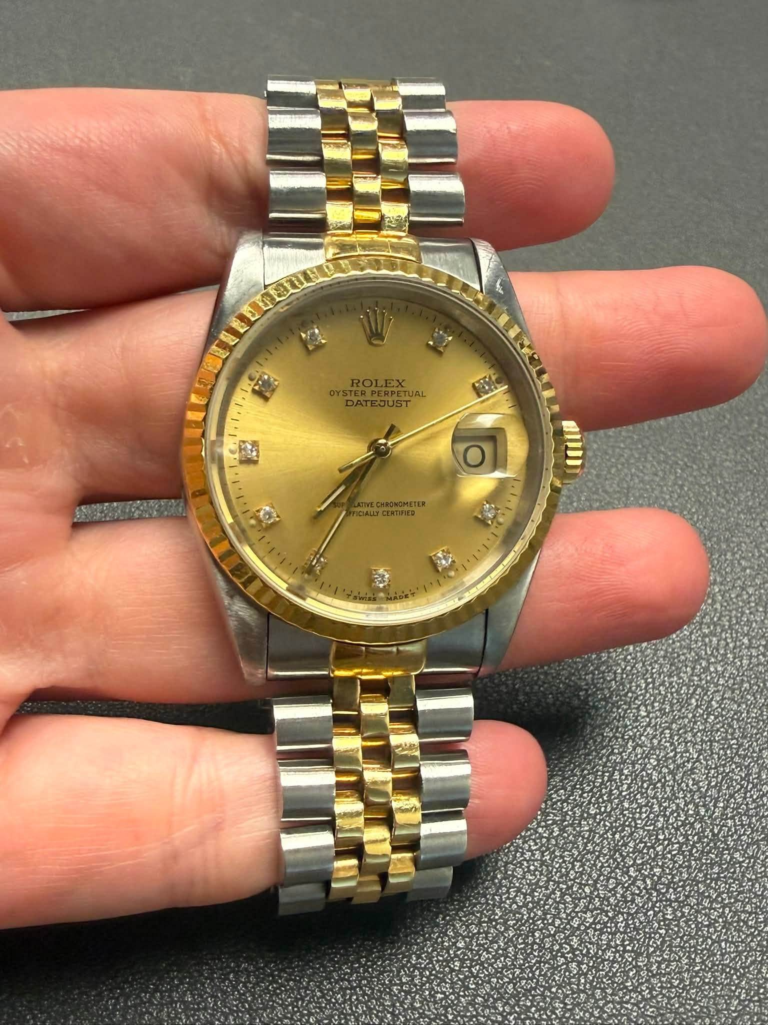 May be an image of wrist watch and text