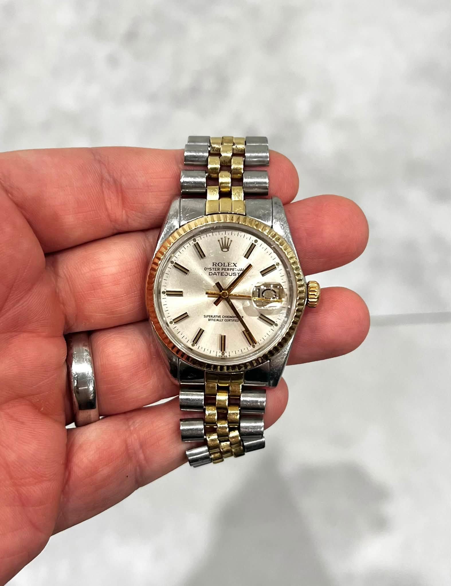 May be an image of wrist watch and text