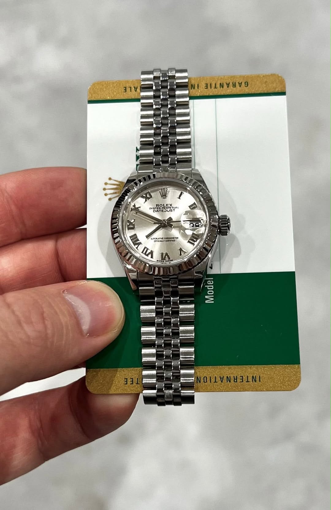 May be an image of wrist watch and text