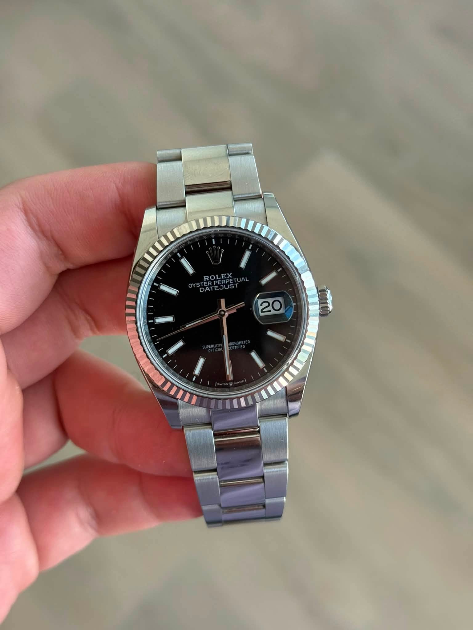 May be an image of wrist watch and text