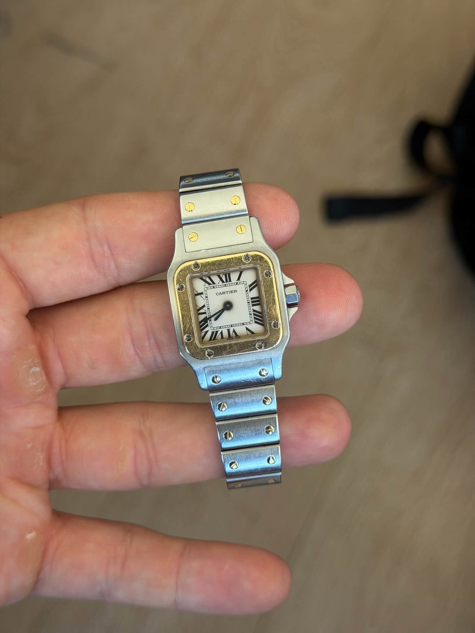May be an image of wrist watch and text that says 'CARTIER ARTIER E o'