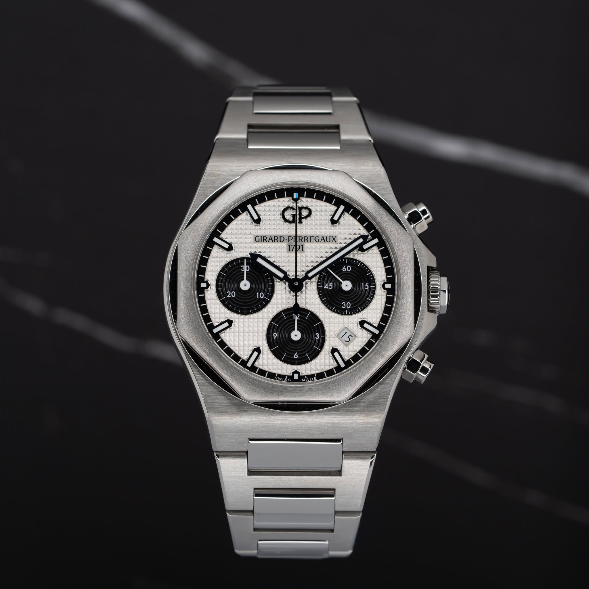 May be an image of wrist watch and text that says 'ل I GIRARD PHRREGAUX EK 1791 20 + 10. IE X E0 ත ק1 ١ 9 9 I πά6 3 1S'