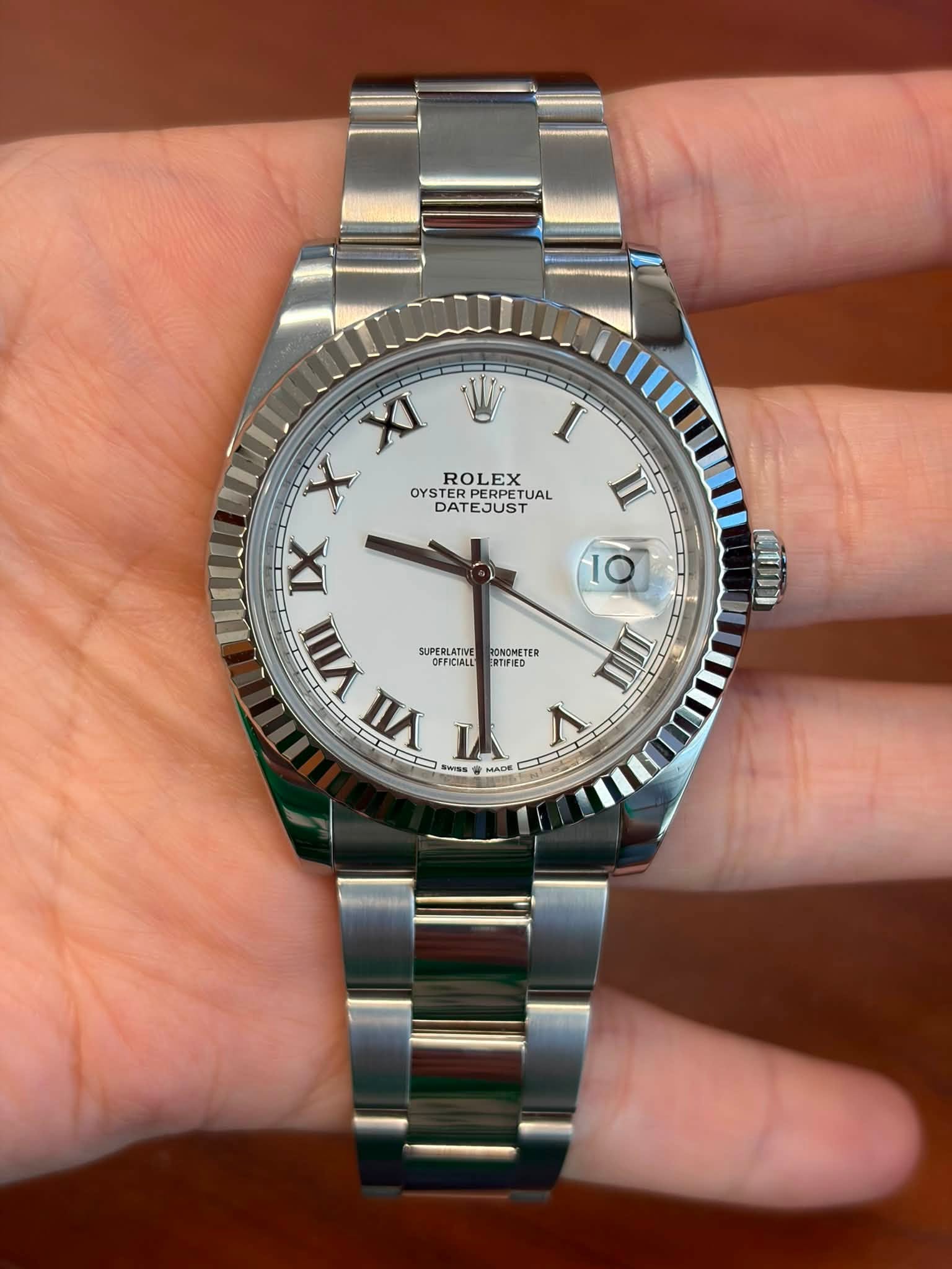 May be an image of wrist watch and text
