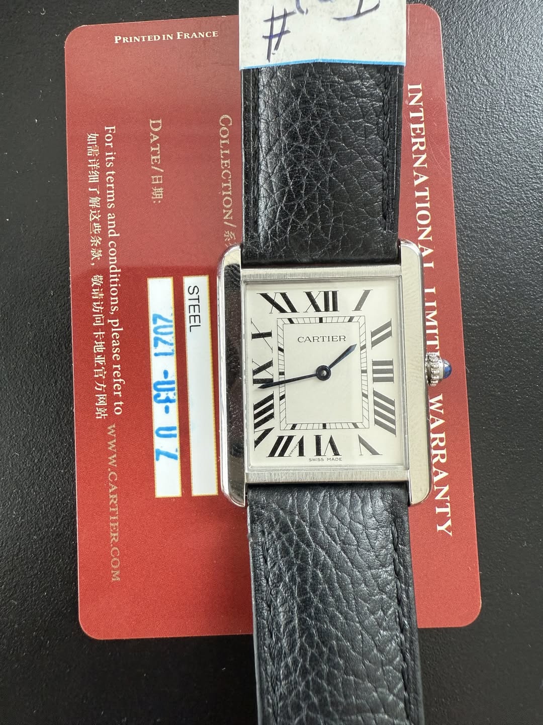 May be an image of leather, wrist watch and text that says 'PRINTED IN FRANCE XI XIXI XII LIHE 如希详細 For its 梅 DATE/日期 and ECT 了解这些条款, terms 渋 敬请访问卡地亚官方网站 敬请访问 conditions, STEEL…