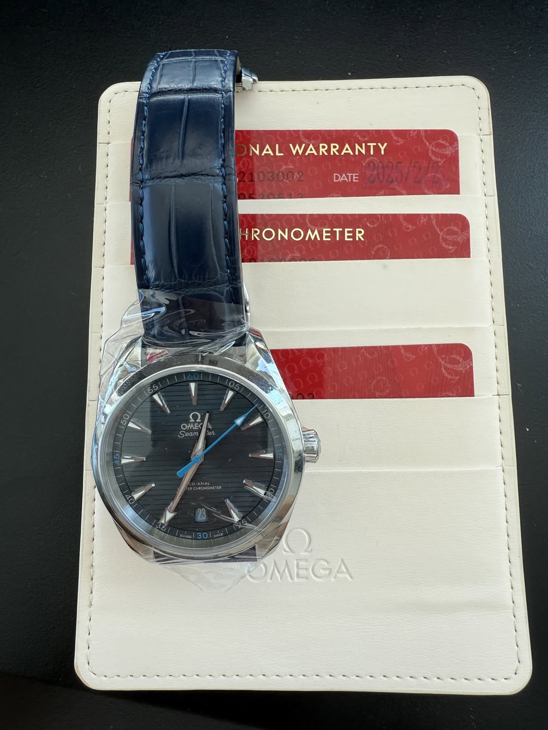 May be an image of wrist watch, leather, leather wallet, saddle-stitched leather and text