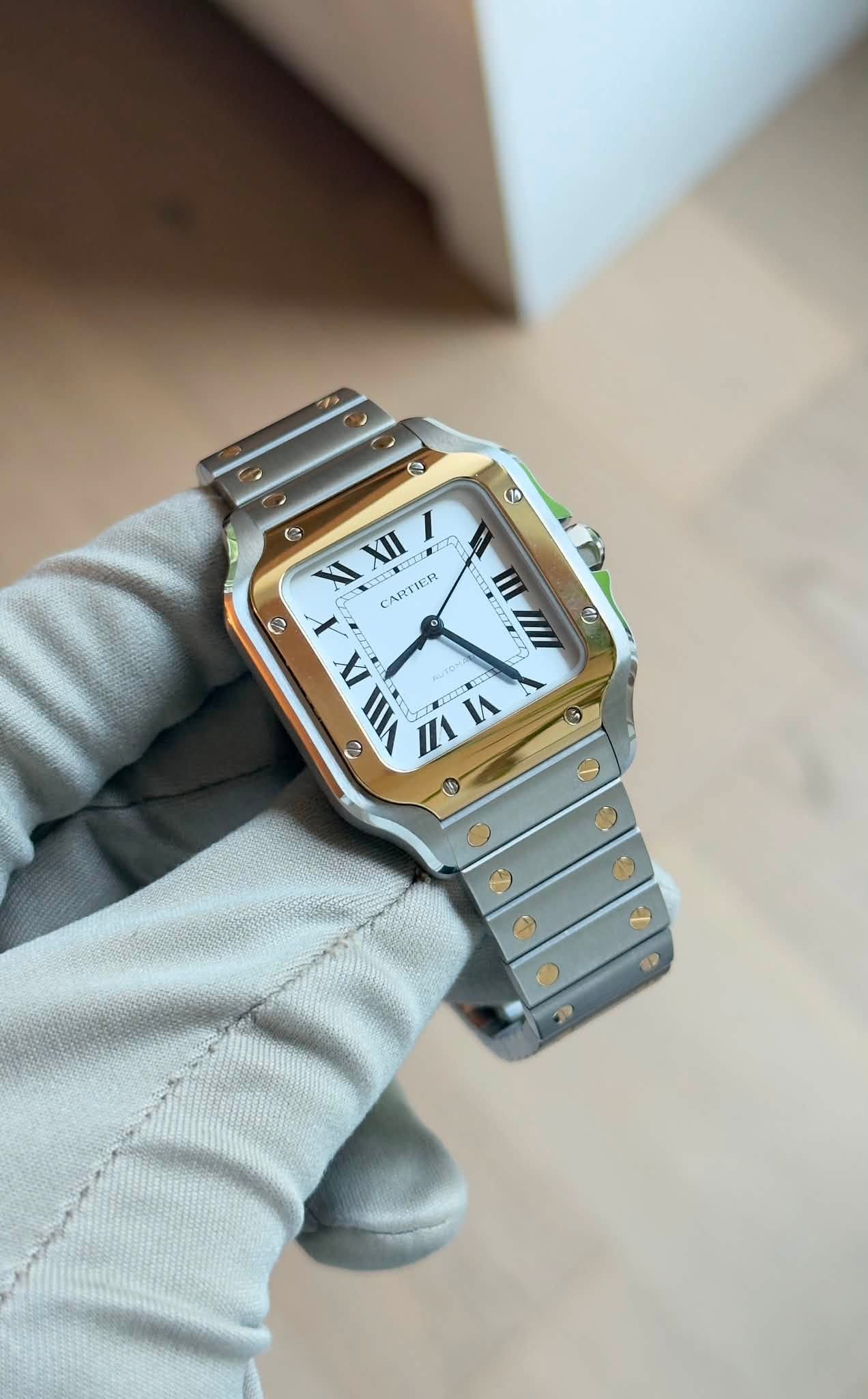 May be an image of wrist watch and text that says 'O S + O XI XII E CARTIER D ምም گ IX VIII ٥ O'