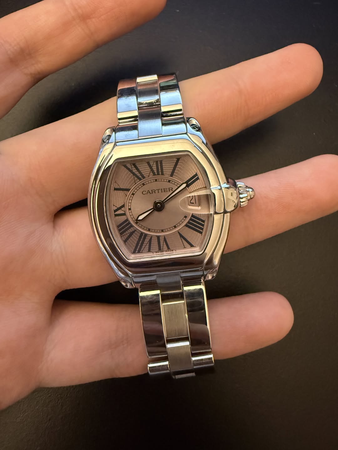 May be an image of wrist watch and text