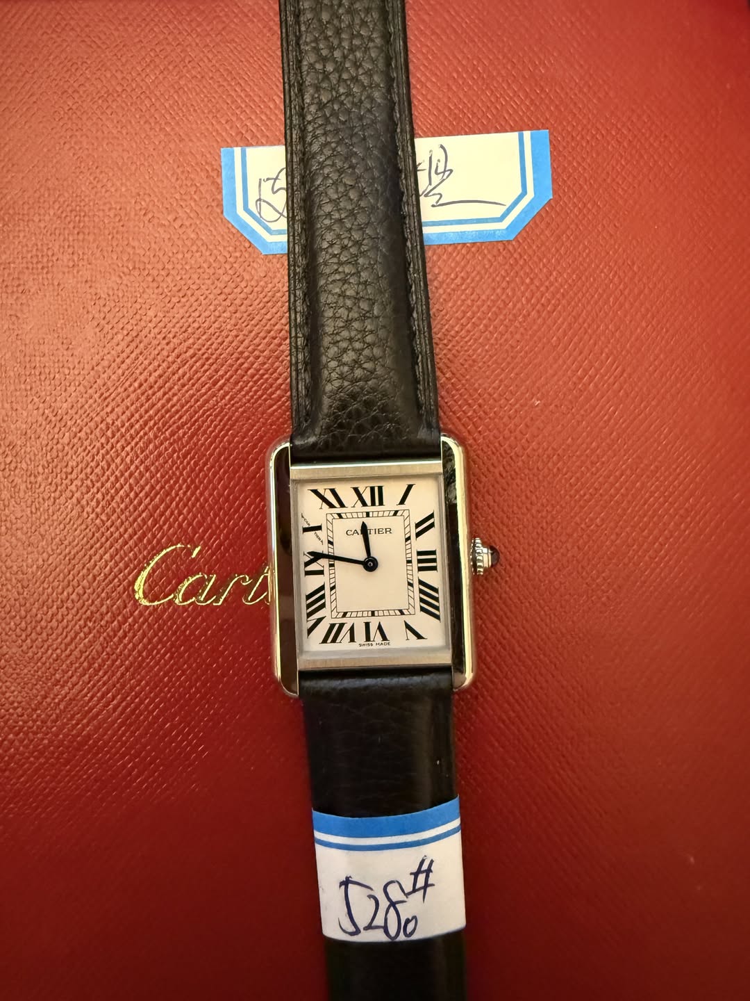 May be an image of digital watch, leather and text