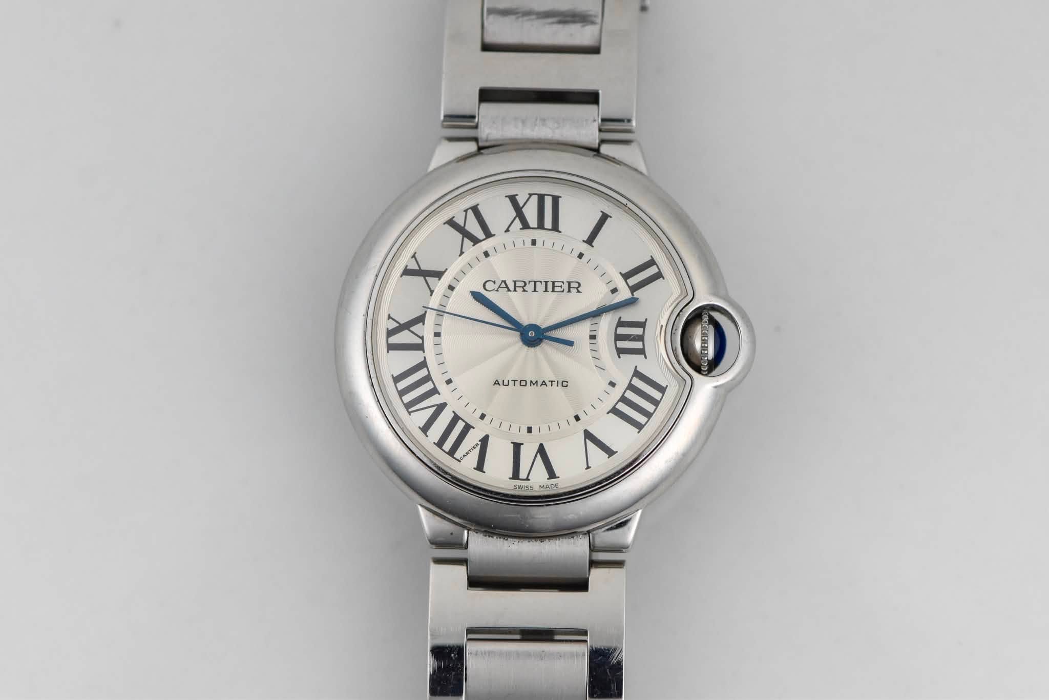 May be an image of wrist watch and text that says 'XI X XIXIII I X CARTIER U + LIM II LNIE W E ባክ et5 VIIVII AUTOMATIC III VI V GE'