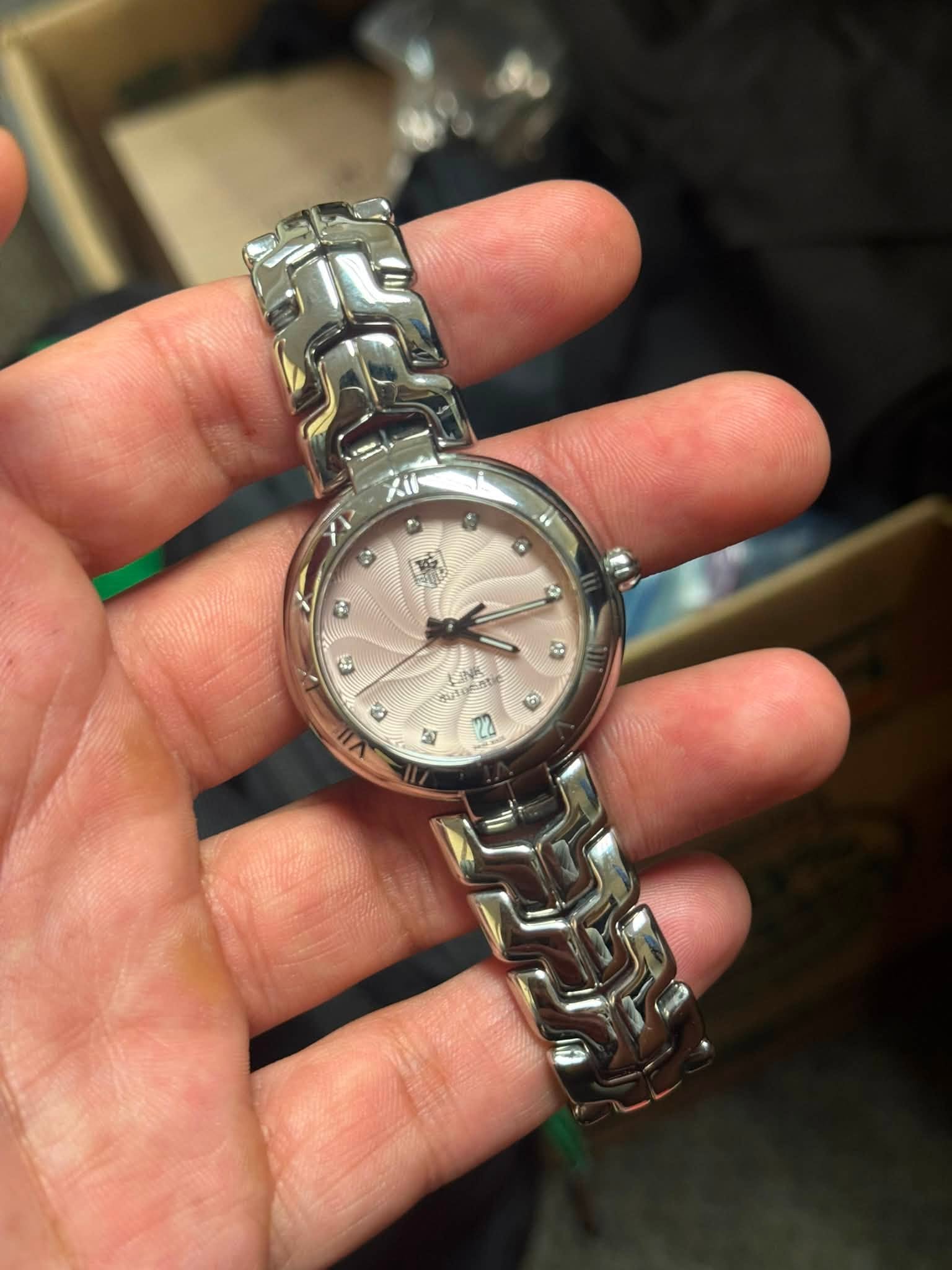 May be an image of wrist watch and text