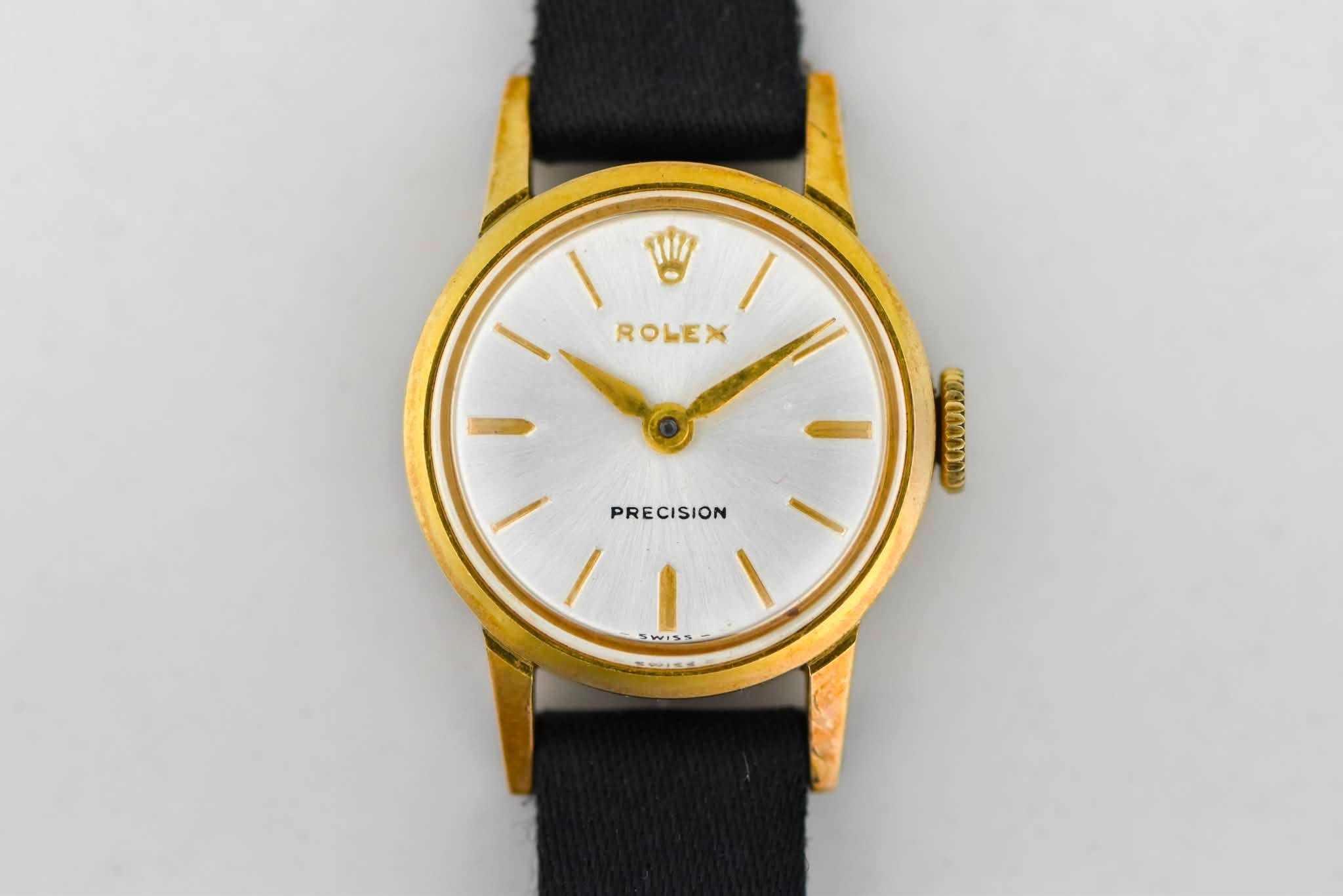 May be an image of wrist watch and text that says '١ ROLEX PRECISION w155'