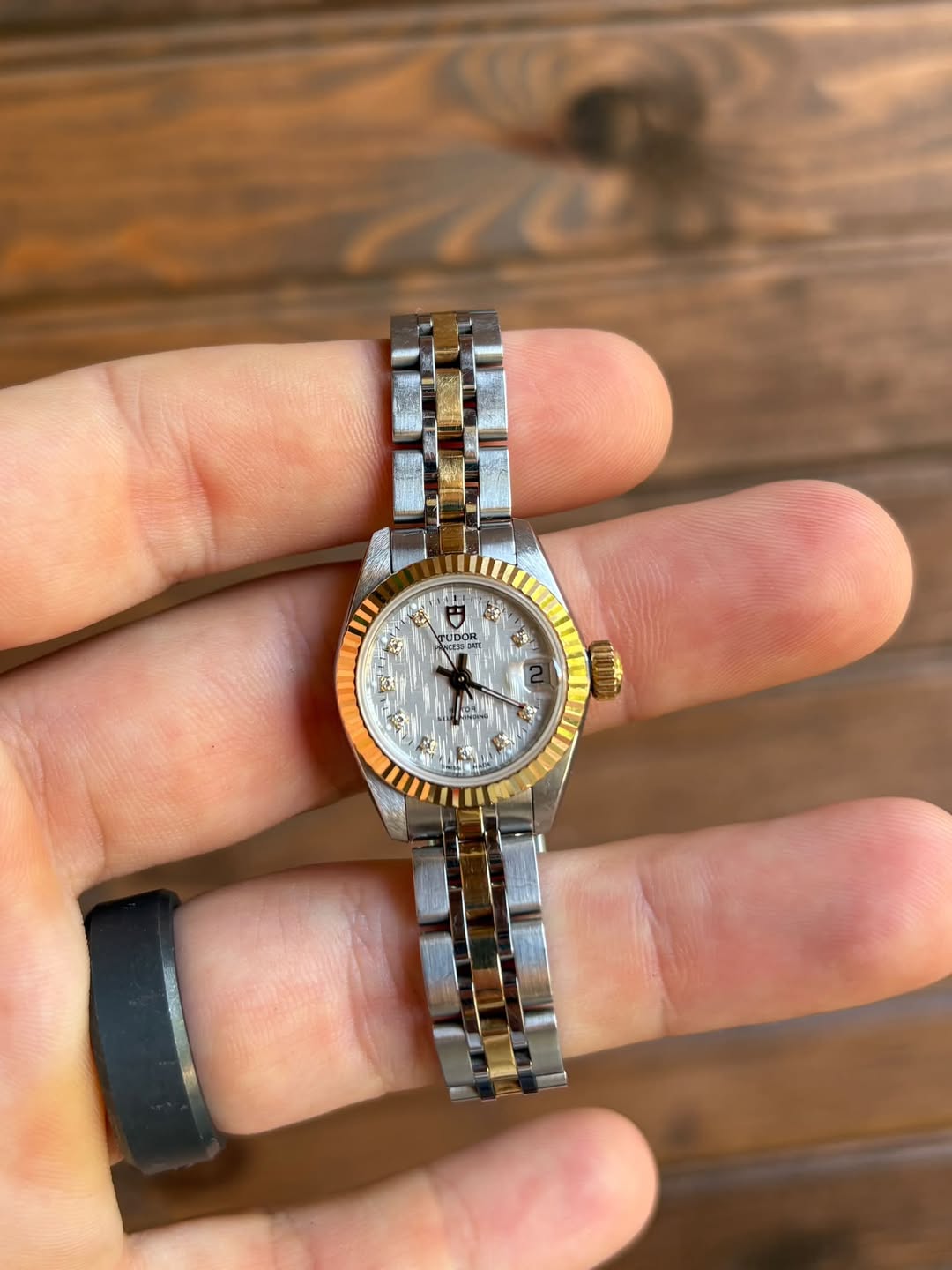 May be an image of wrist watch and text