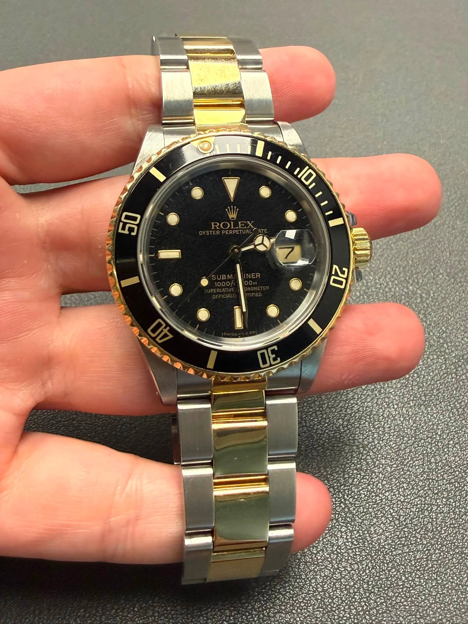 May be an image of wrist watch and text