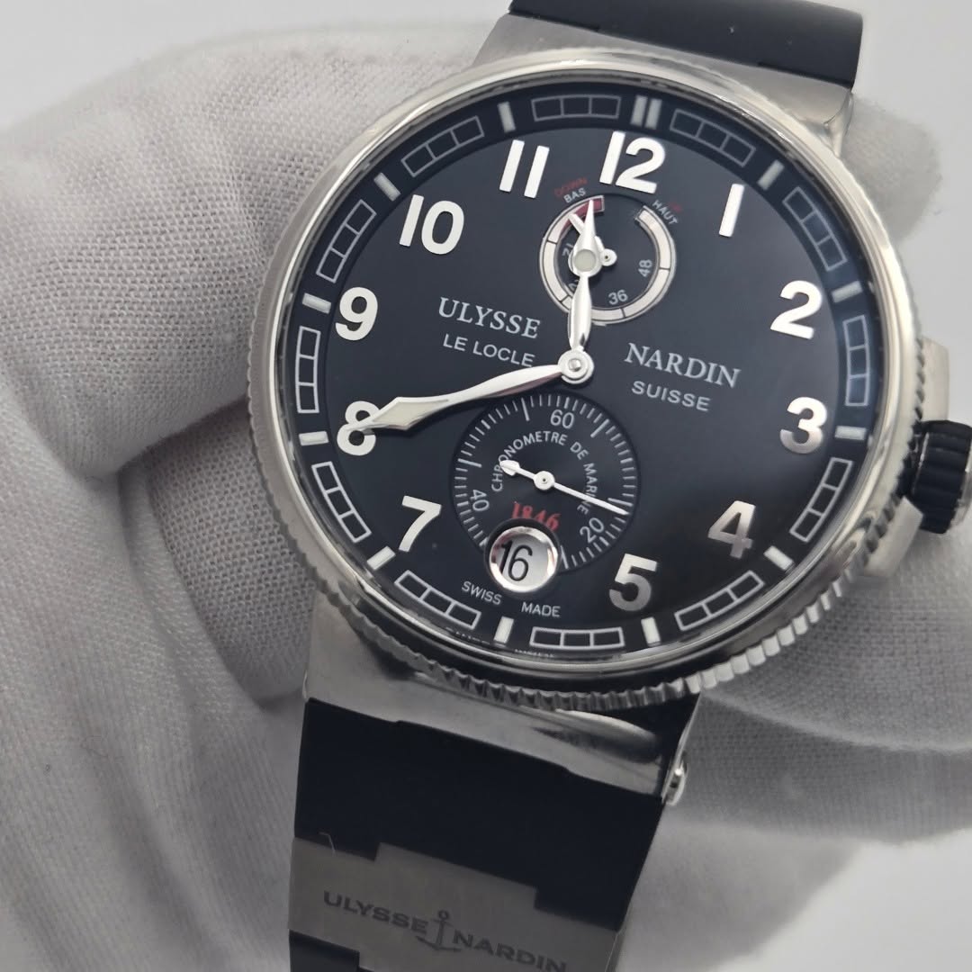May be an image of wrist watch and text that says 'II 12 II IO 9 ULYSSE LE LOCLE B% 36 60 OME METRE DE 2 ا NARDIN SUISSE 3 8 7 of DD W SWISS 20 o 5 MADE'