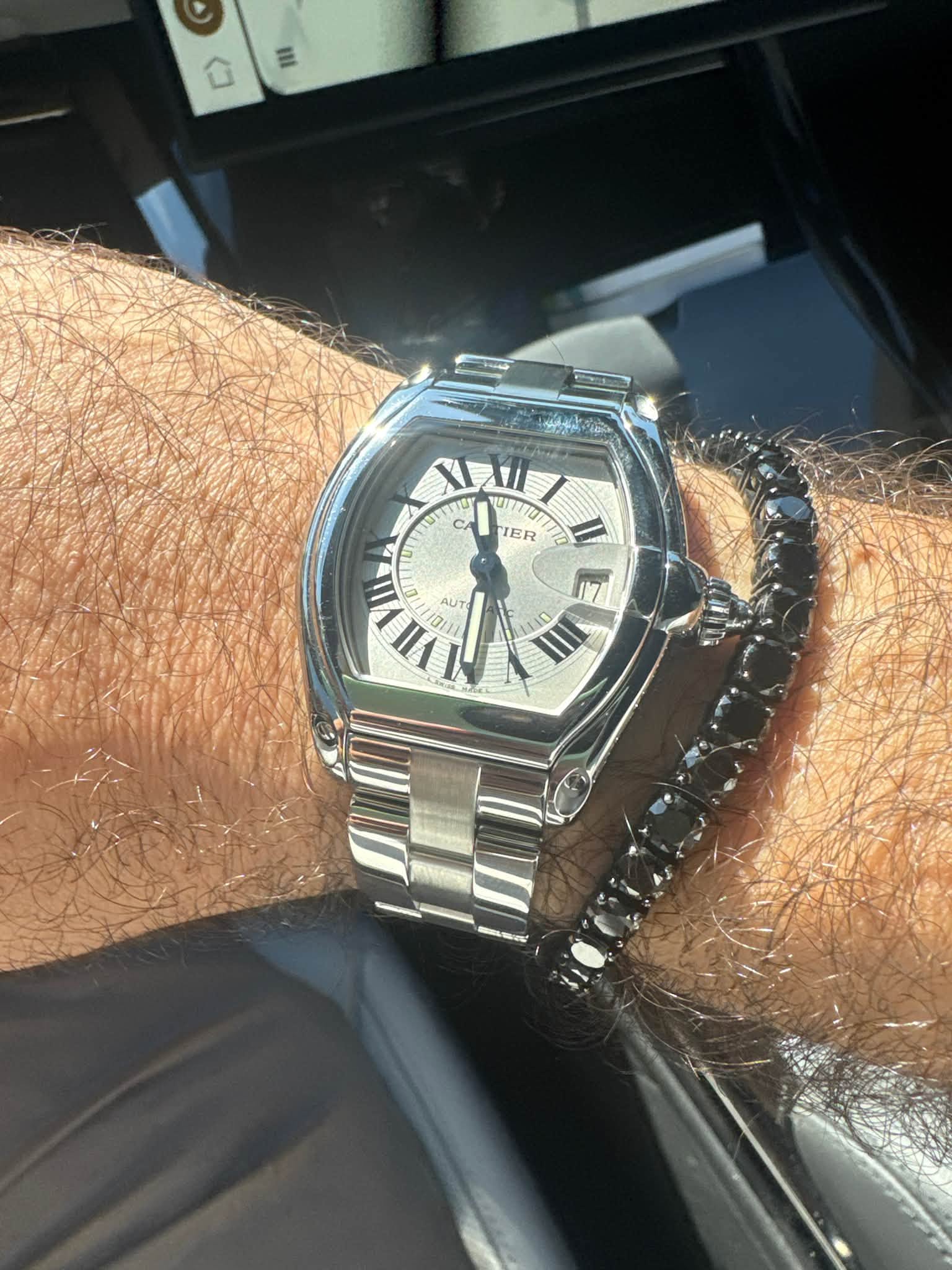 May be an image of wrist watch and text