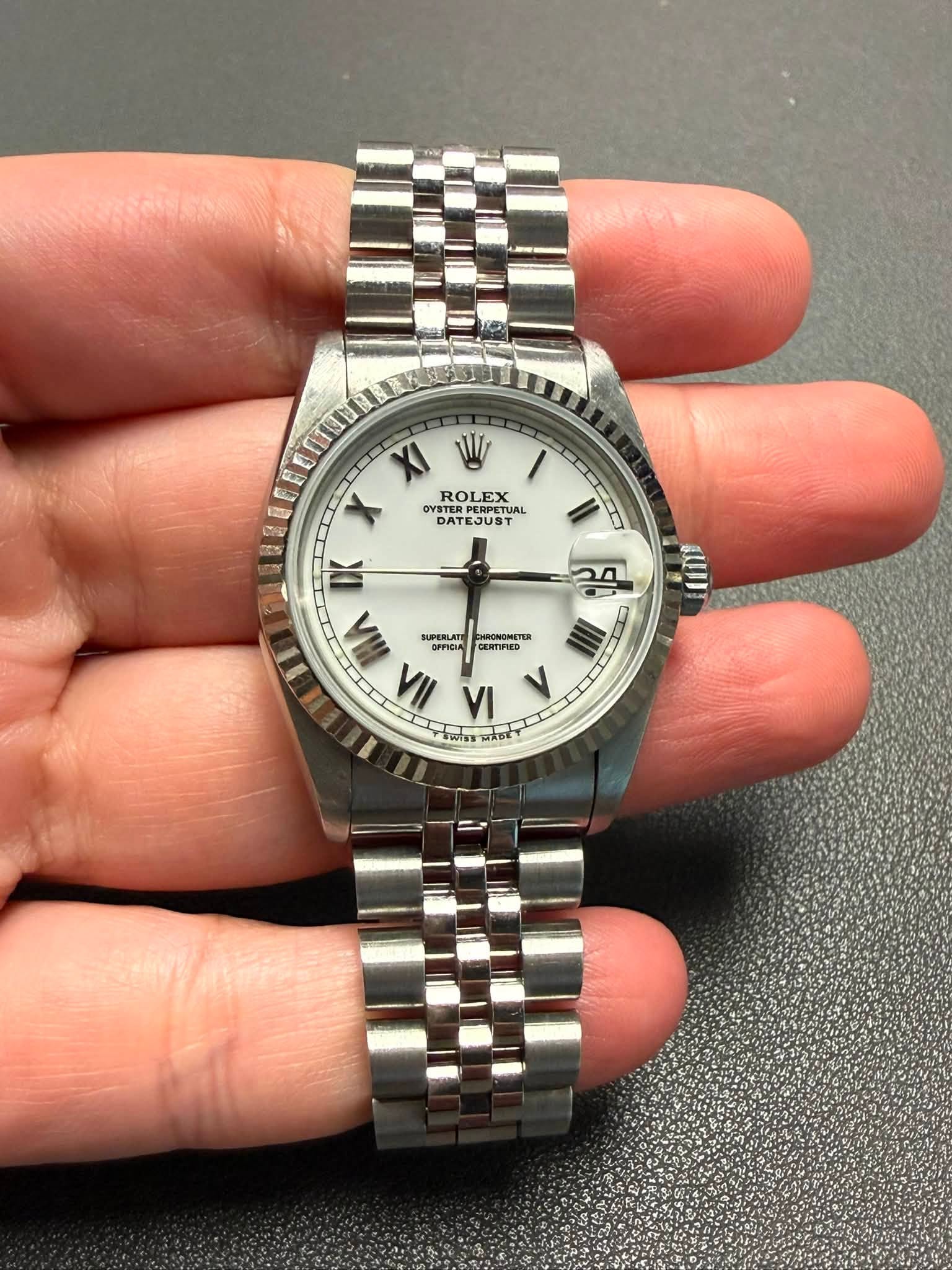 May be an image of wrist watch and text