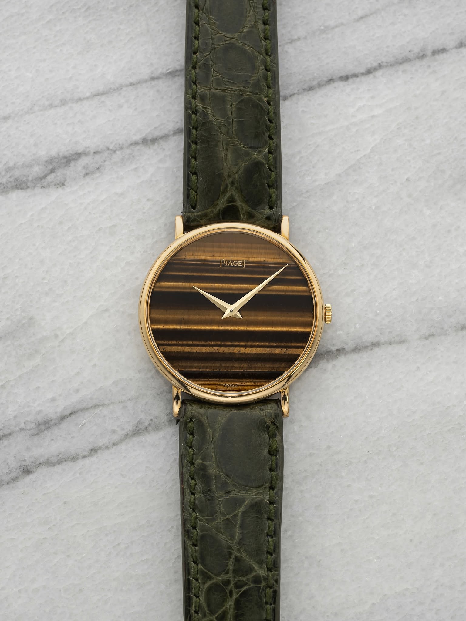 May be an image of wrist watch, leather and text