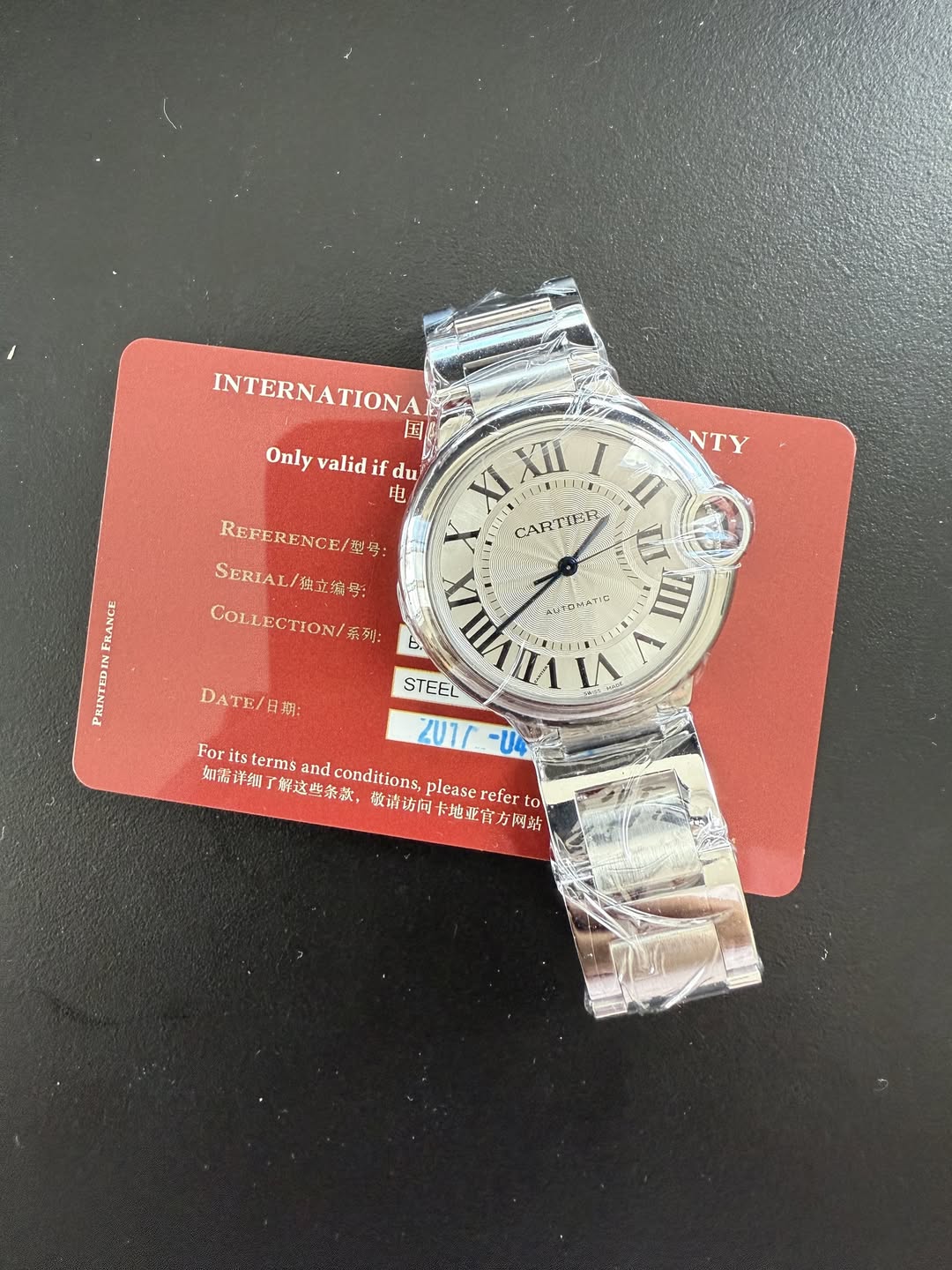 May be an image of wrist watch and text that says 'NTY INTERNATIONA 国 Only valid Onlyvalidifdu if du 电 XI XII KIXI/ I EIU REFERENCE/4: CARTIEE rだ日 n SERIAL SERIAL/鶴立编号: /独立编号…