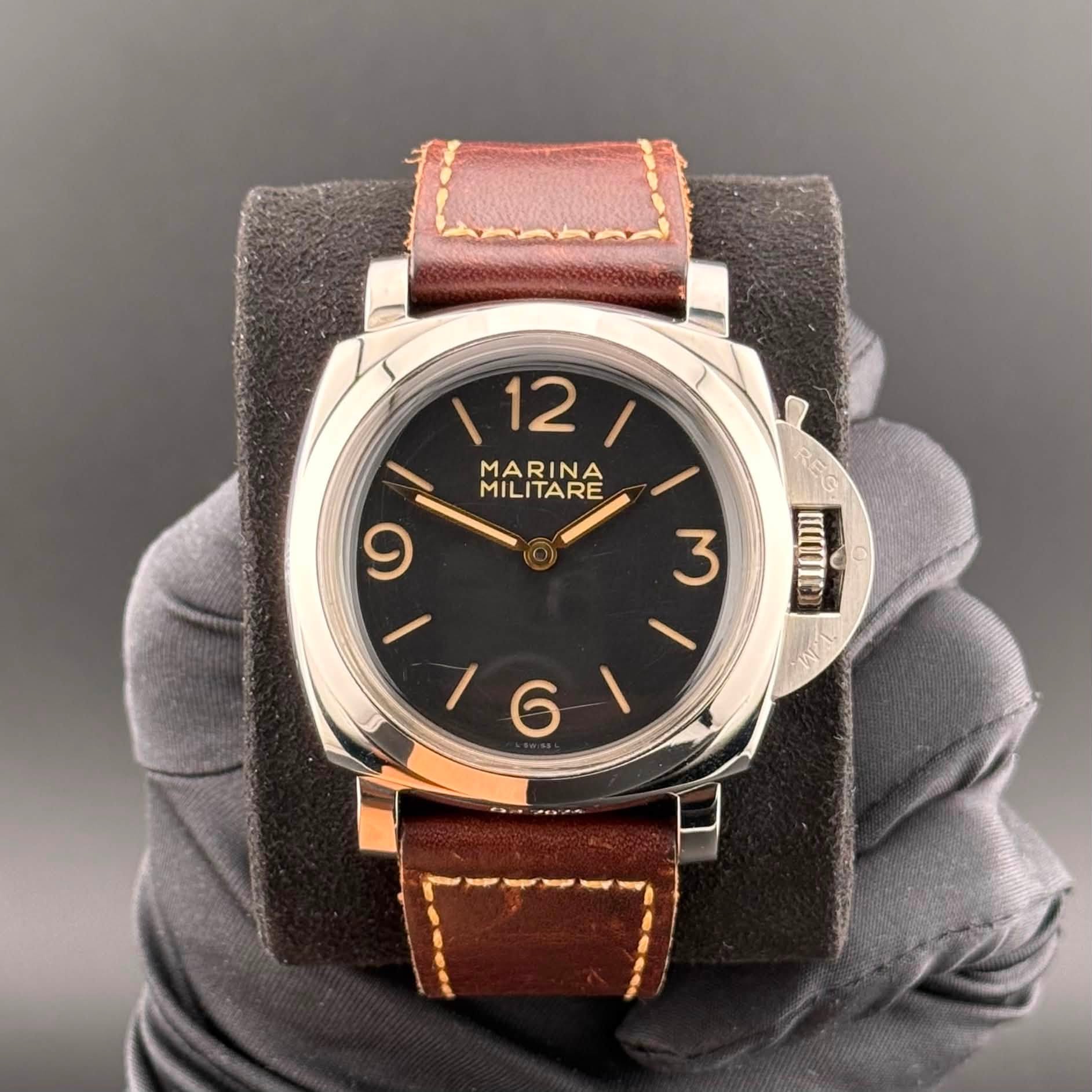 May be an image of leather, wrist watch and text