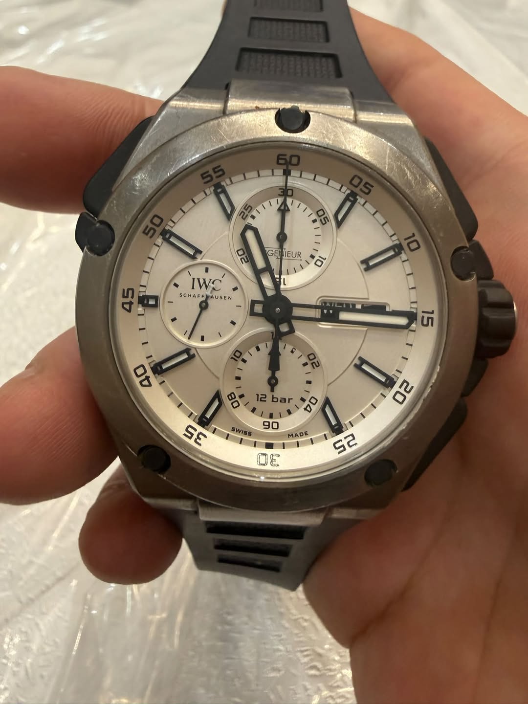 May be an image of wrist watch and text that says 'LLI ELP 20 ILD 05 GE GENIEUR ገ IWC SCHARP AUSEN in 45 U bar 0E DO 10 SWISS 2 20 SE 90 MADE ADE 13 G 52 ល'