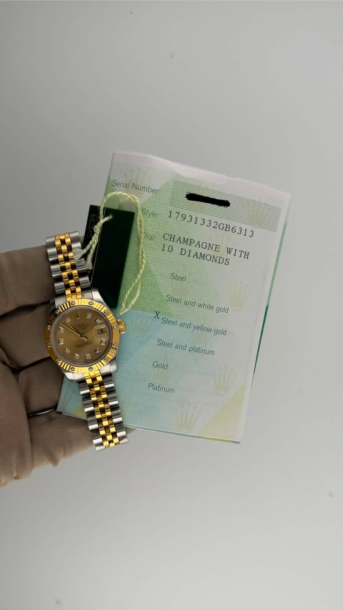 May be an image of wrist watch and text that says 'Serial SerialNumberi Numberi Style: 17931332GB6313 ial: 10 CHAMPAGNE DIAMONDS WITH Steel Steel and white gold X Steel and yellow…