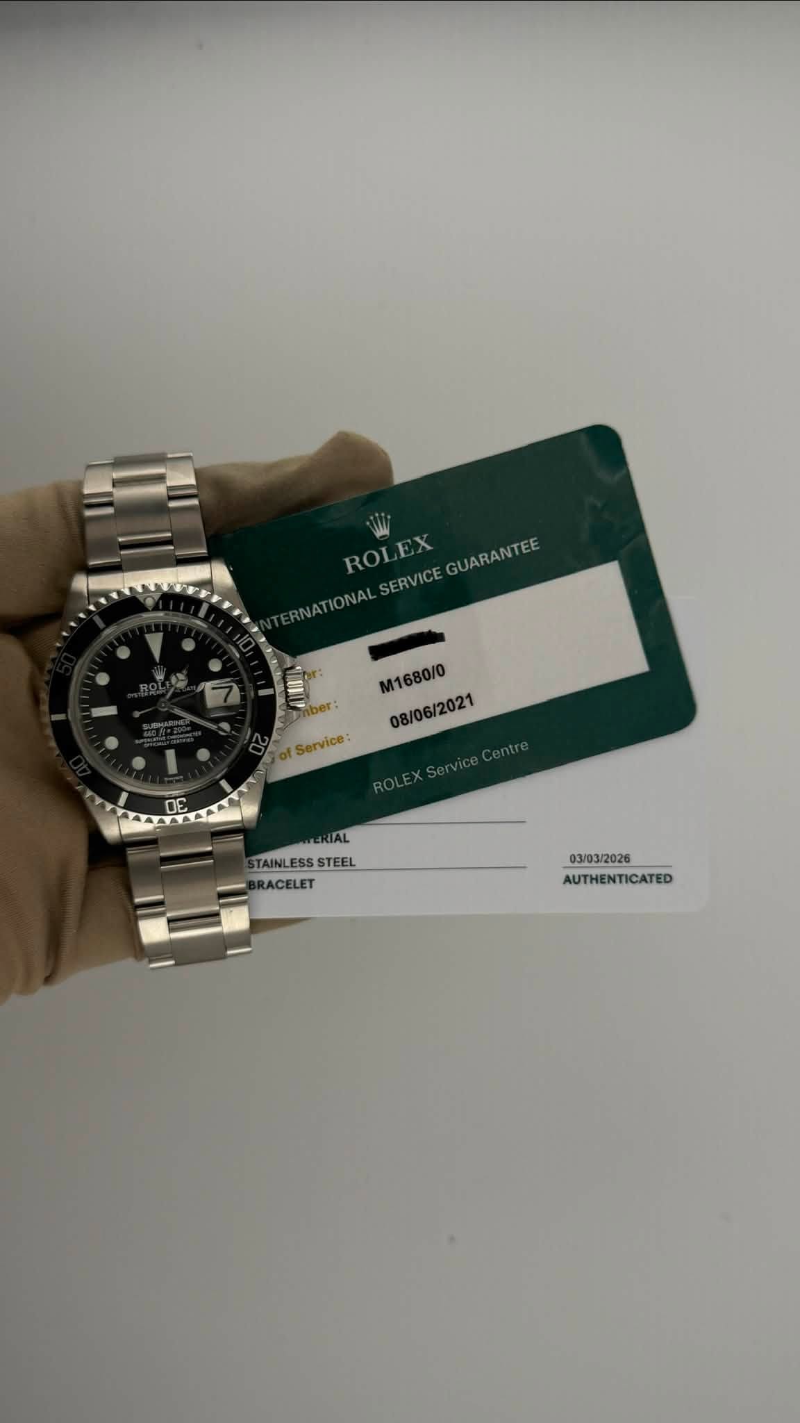 May be an image of wrist watch and text that says 'INATIONALSERVICEGUARANTEE NATIONAL ROLEX W ROL JARANTEE SERVICE S M1680/0 08/06/2021 Service: TAINLE TAINLESSSTEEL STANLESSSTEEL…