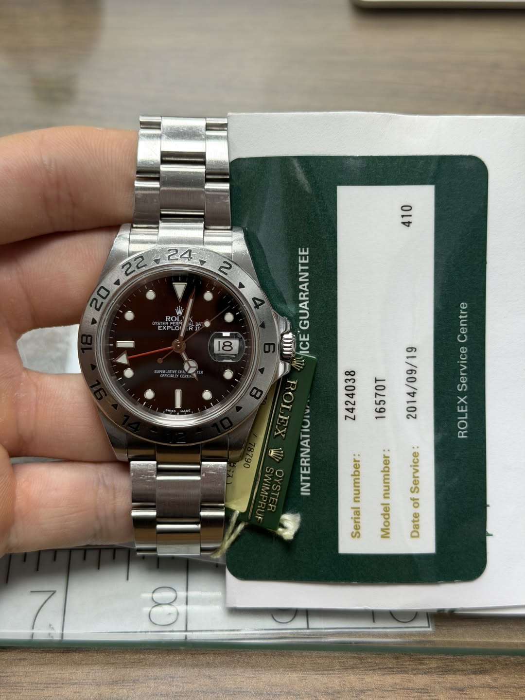 May be an image of wrist watch and text that says '三 II 감 ROL OL U 18 I GUARANTEE μa ICE ! TOd Z424038 16570T 014/09/19 X M INTERNATIO Centre Service ROLEX number: number Service:…