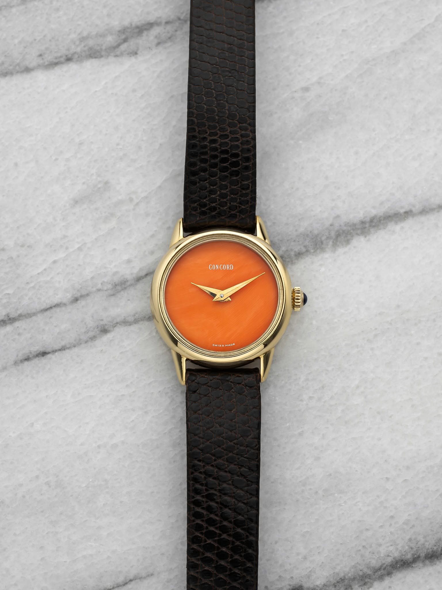 May be an image of leather, wrist watch and text