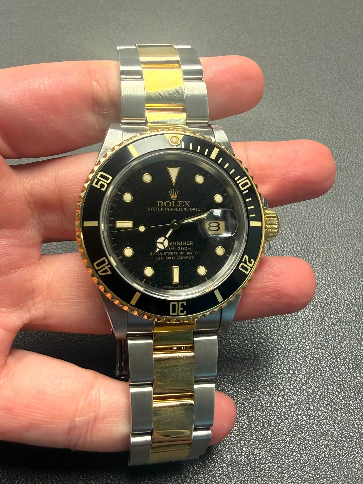 May be an image of wrist watch and text