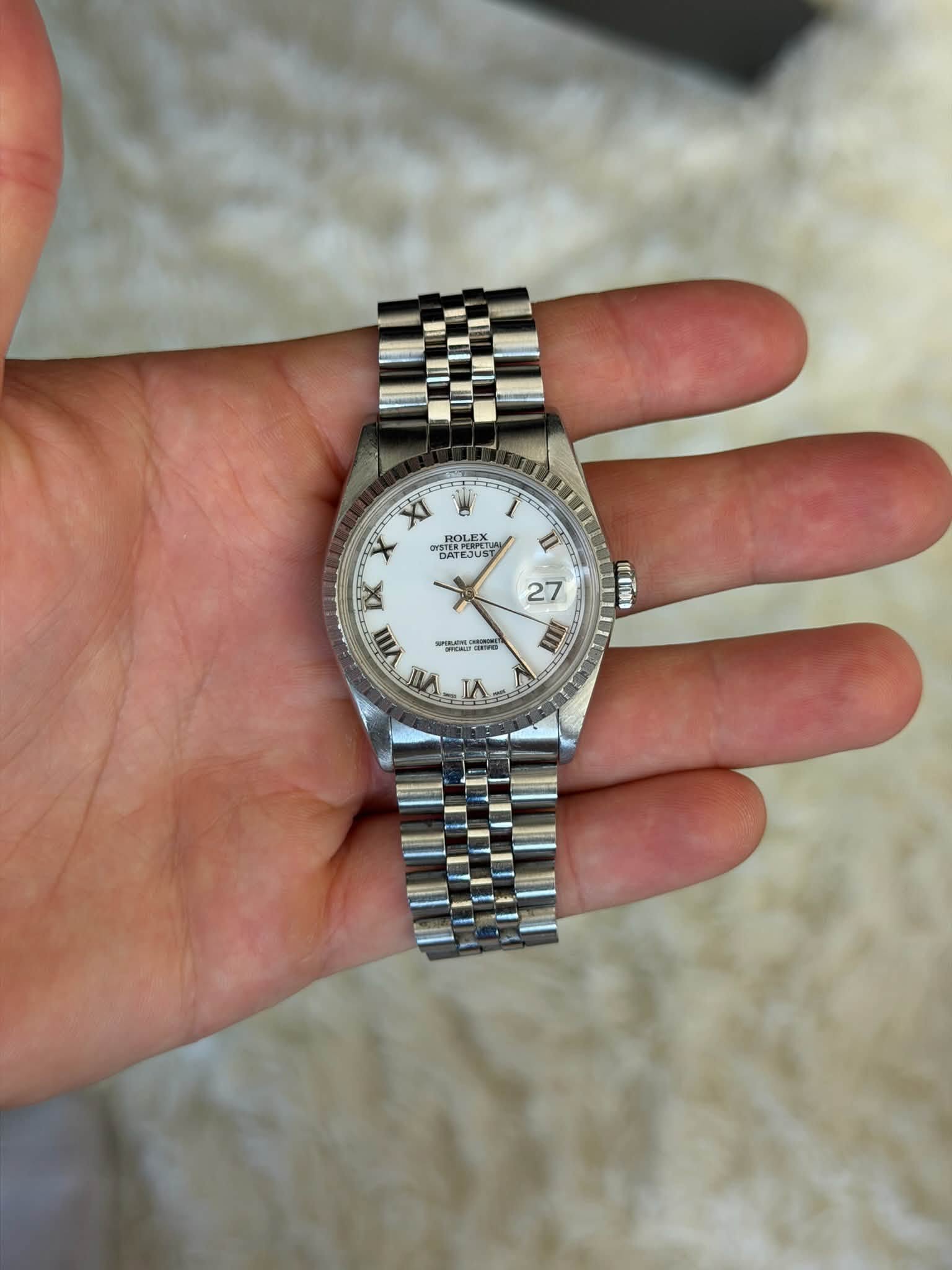 May be an image of wrist watch and text