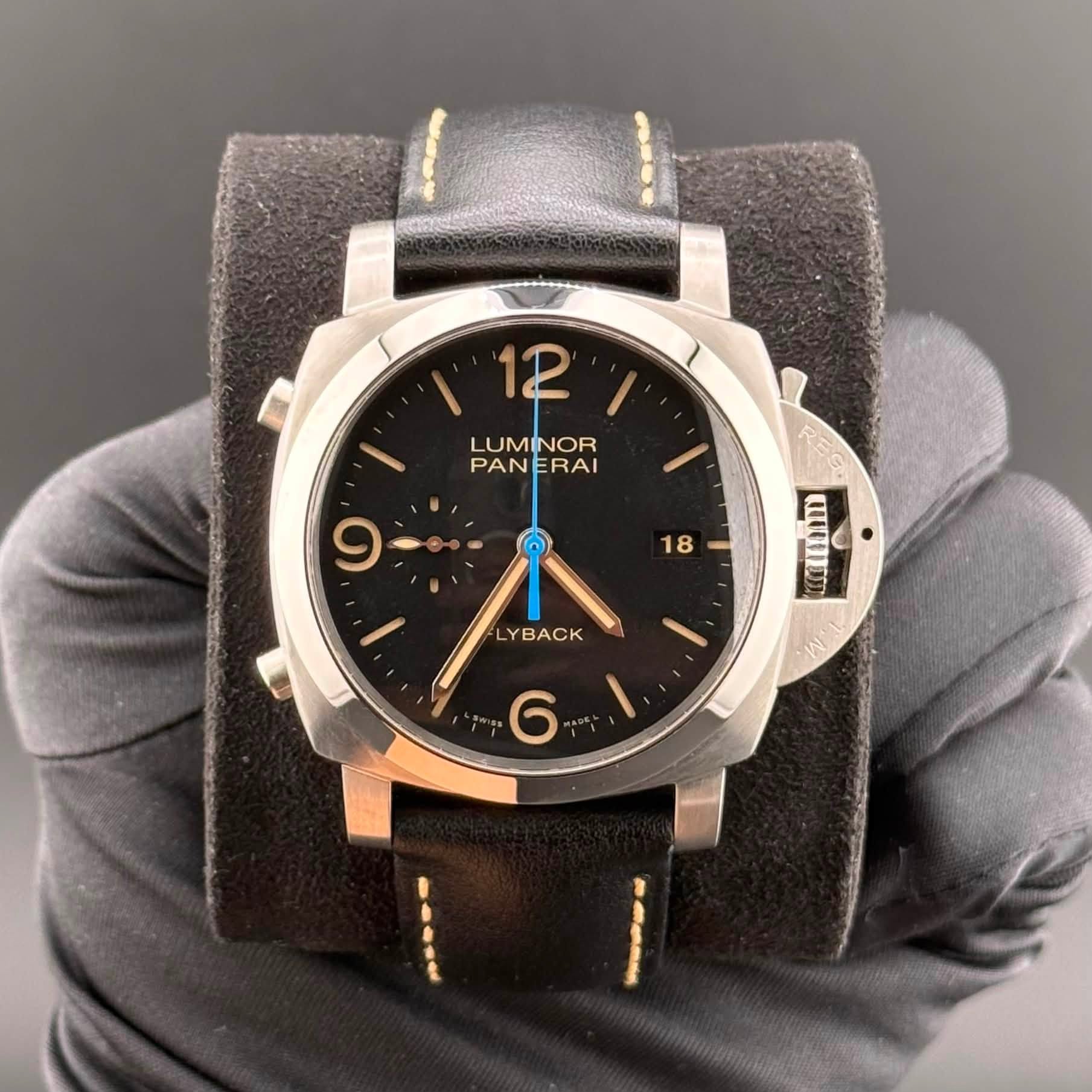 May be an image of leather, wrist watch and text