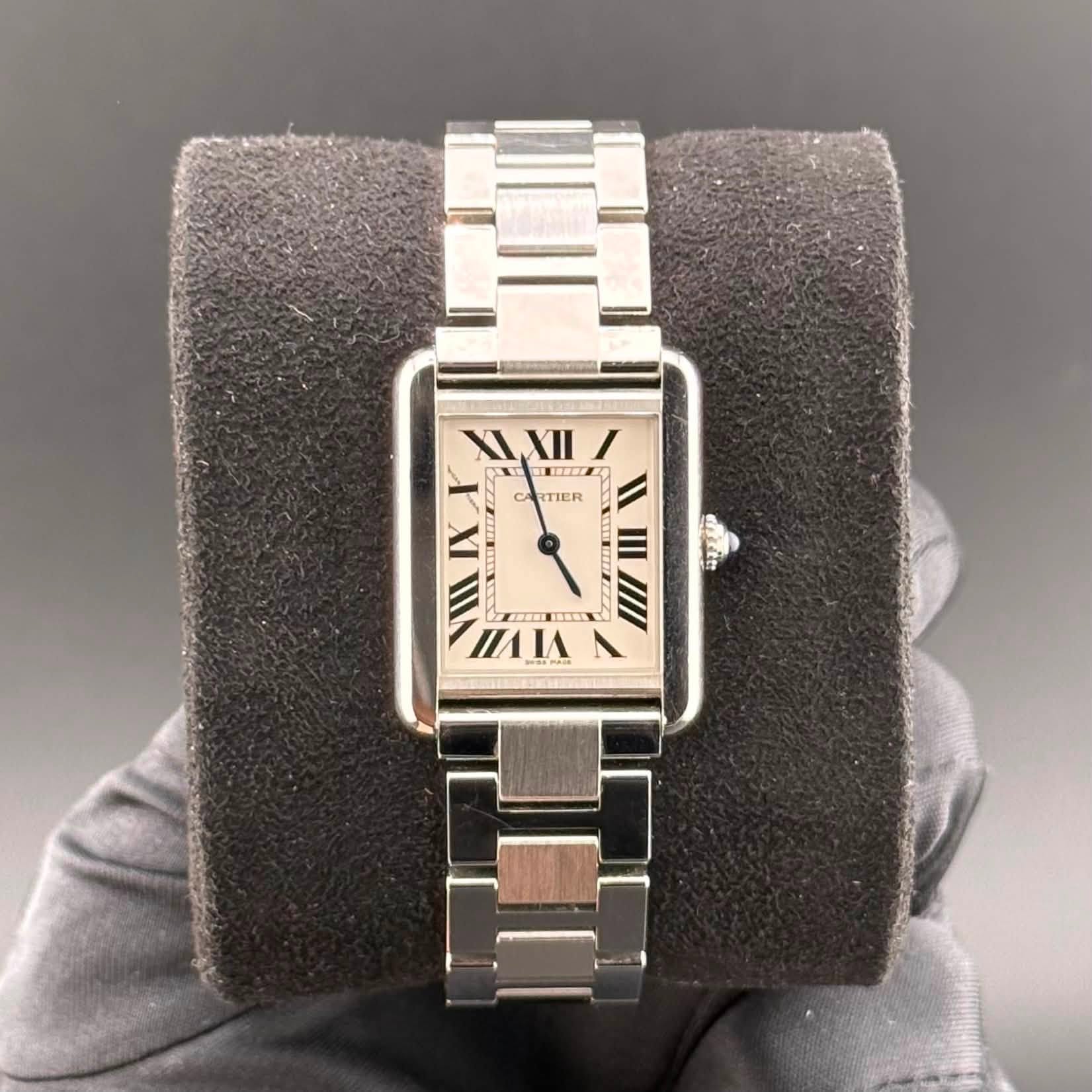May be an image of wrist watch and text