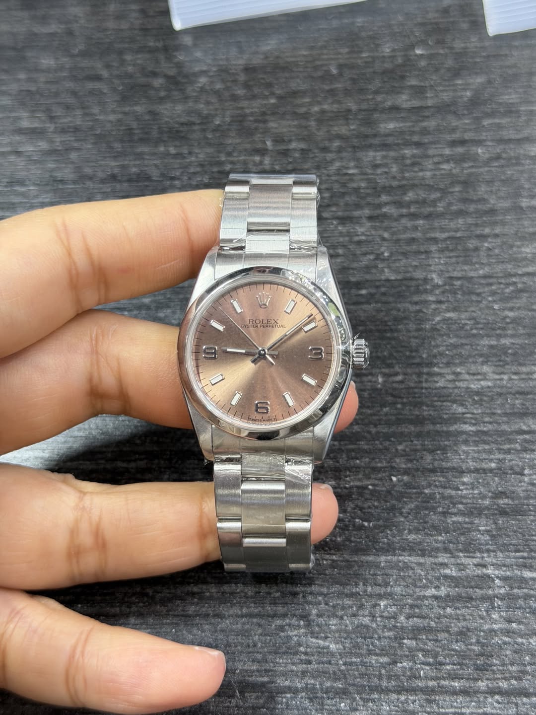 May be an image of wrist watch and text