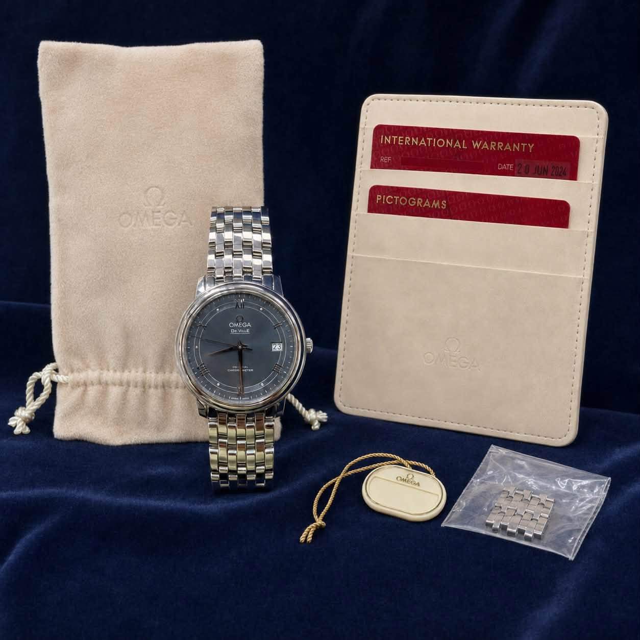 May be an image of leather wallet, leather, saddle-stitched leather, wrist watch and text that says 'INTERNATI INTERNATIONALW WARR WARRANTY INTERNATIONALWARRANTY AN OMECA…