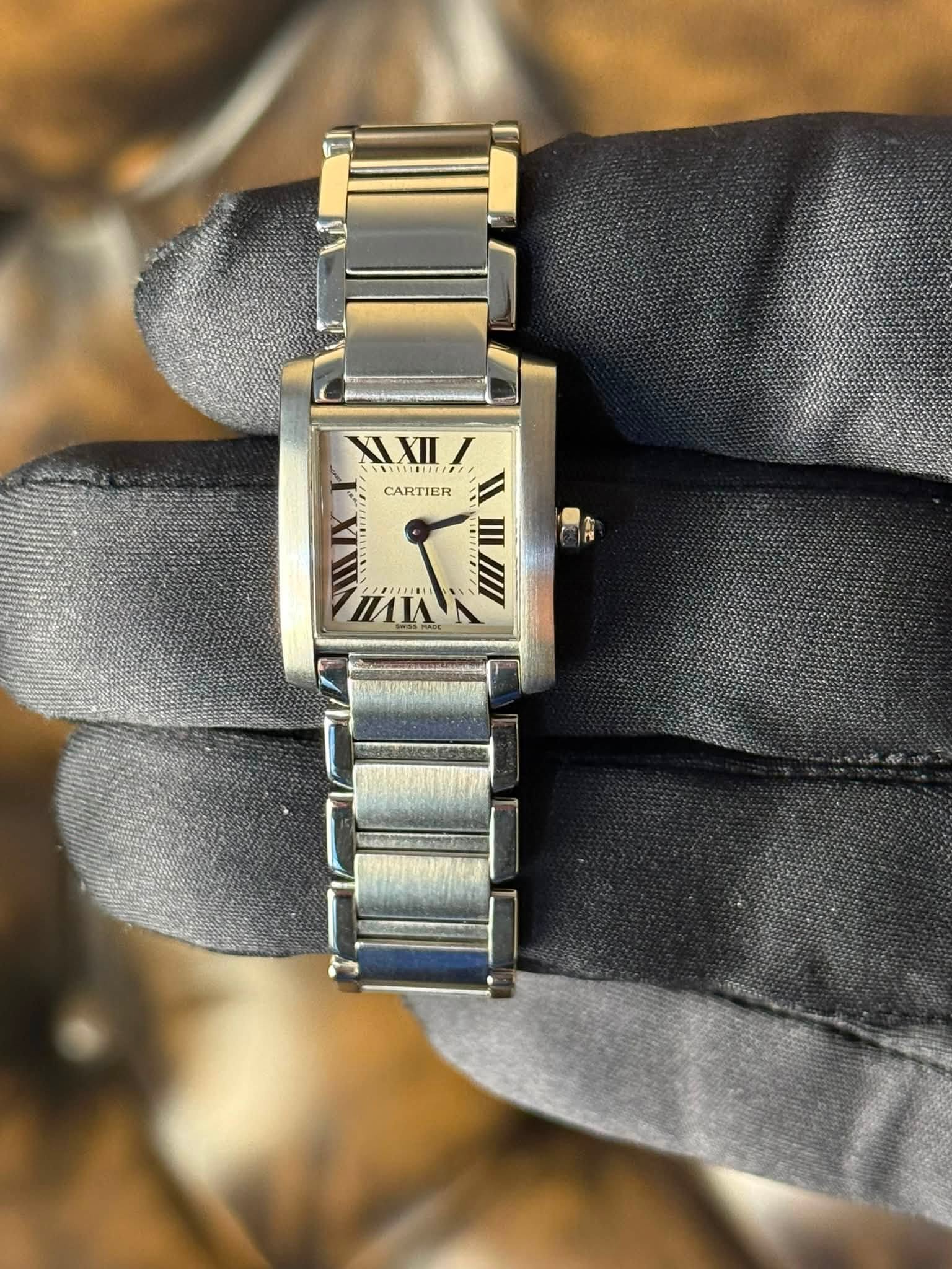 May be an image of digital watch and text that says 'XIXII CARTIER M م'