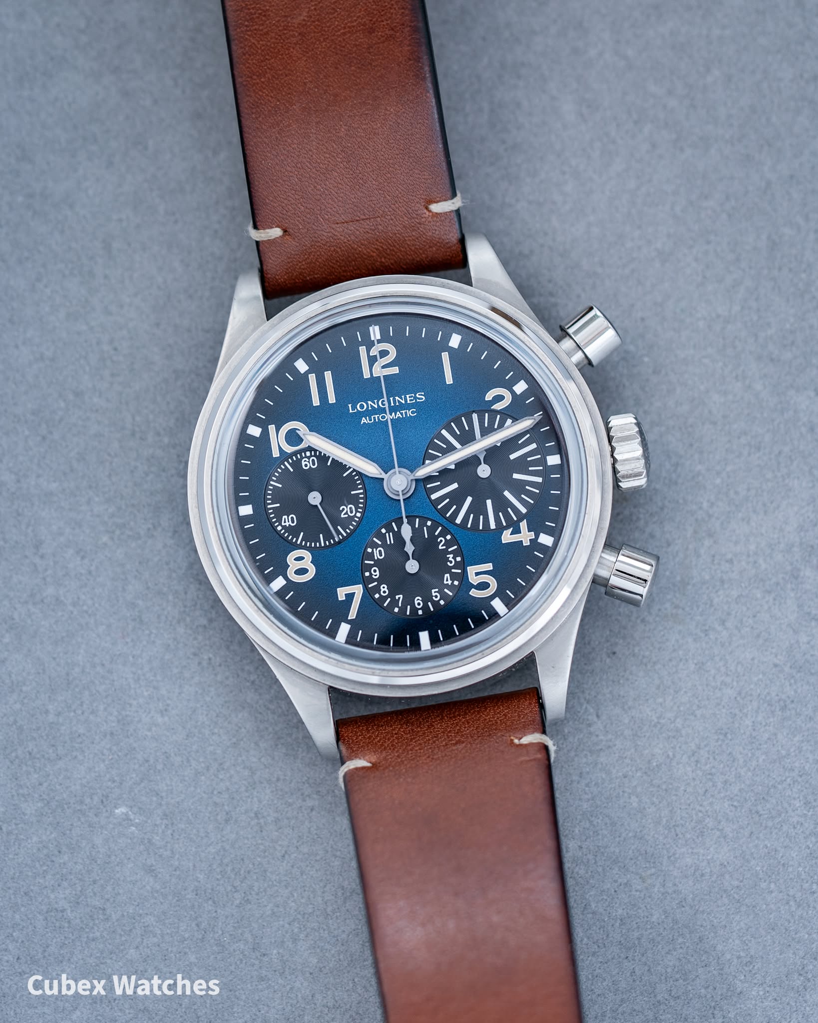 May be an image of ‎wrist watch and ‎text that says '‎12 11 LONG LONGINES INES IG 60 ATOMAT NUTO 0 20. 40 i Ta 8 Il * B ربي ባ N + 3 ഗ 4 F O 0 I Cubex Watches‎'‎‎