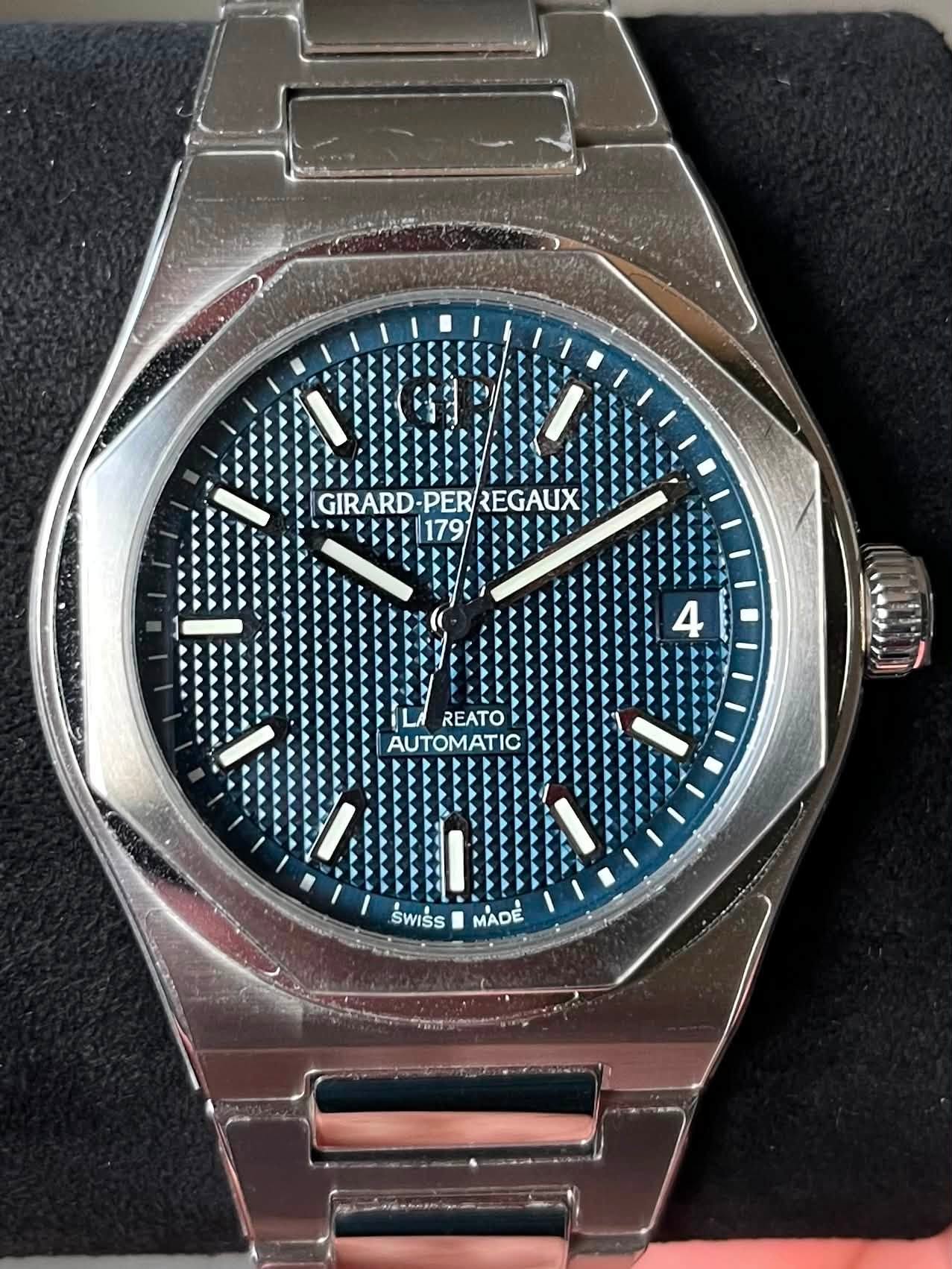 May be an image of wrist watch and text that says 'GIRARD GIRARD-PER/REGAUX PER REGAUX 179 REATO AUTOMATIC パキ.ナリン SWISS ร MADE'