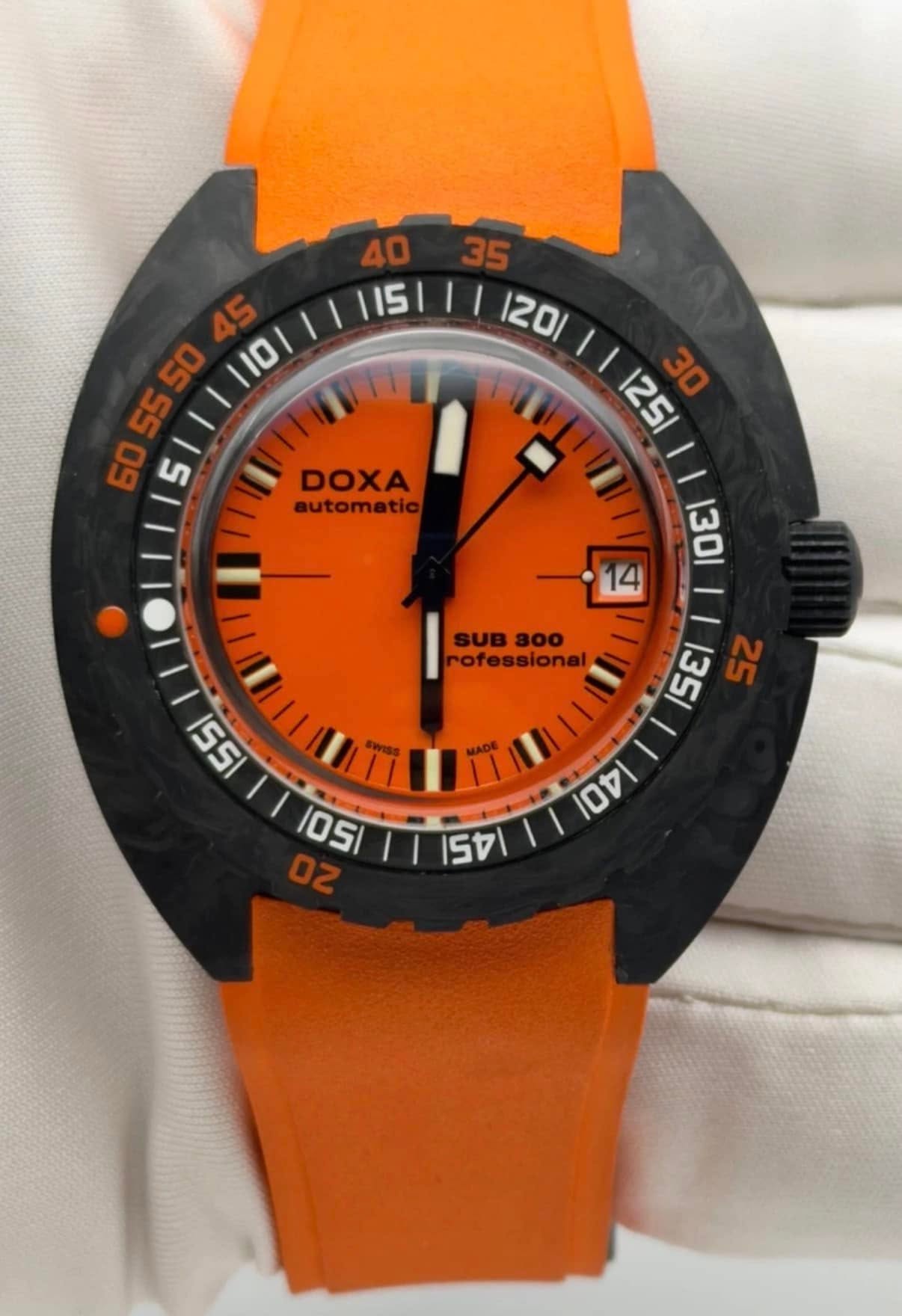 May be an image of ‎wrist watch and ‎text that says '‎ 6O DOXA automatic / 115 120/ ١ 125 30 | מ5וווגם I1 5E1 I rofessional |u00 1SE1 SZ 55 10SITT 154/ 4 07 05 OZ‎'‎‎