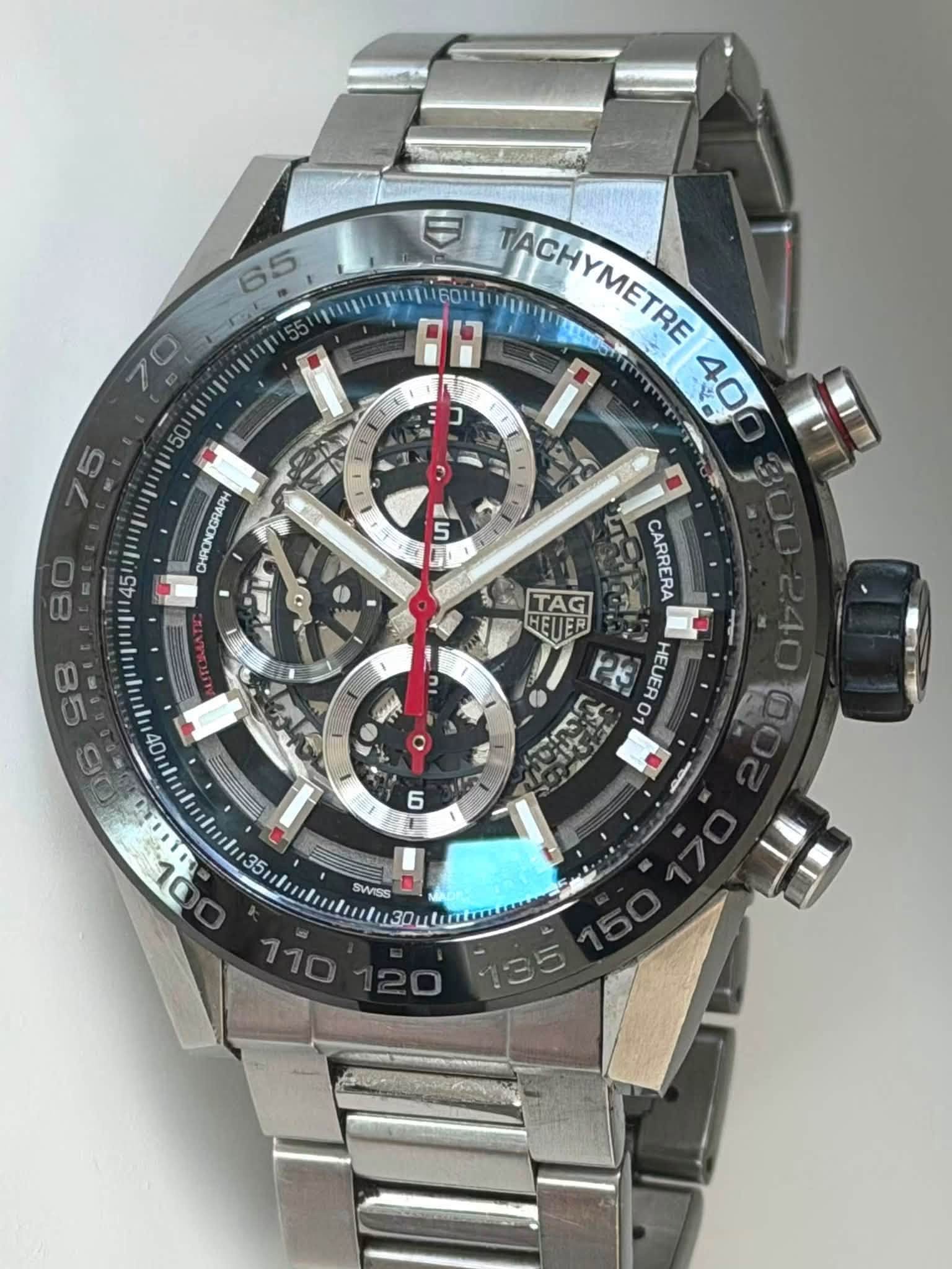May be an image of wrist watch and text that says ' TACHYMETRE し ㄱ 400 HOPECONOAHO 5 S1 80 8 JMA B CARRERA 당 4 ETER AG 20 산 O HEUERO IU WAME 6 仁 DL 1uli35 က 0 SWISS ル〇 Su'