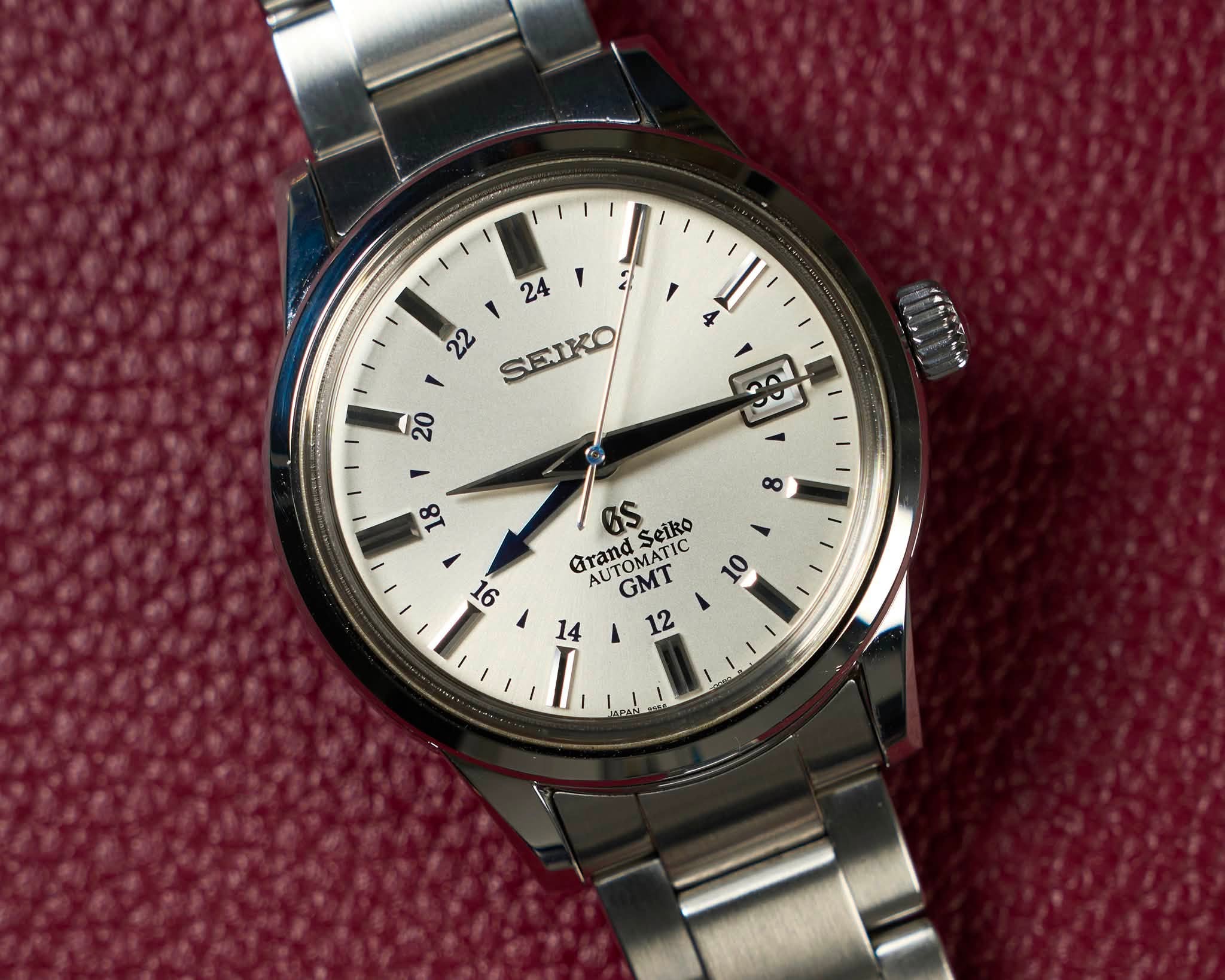 May be an image of wrist watch and text that says ' SENKO $ Seiko Grand TM GTanOMATIC AU TIC 10 GMT 12 14 I.'