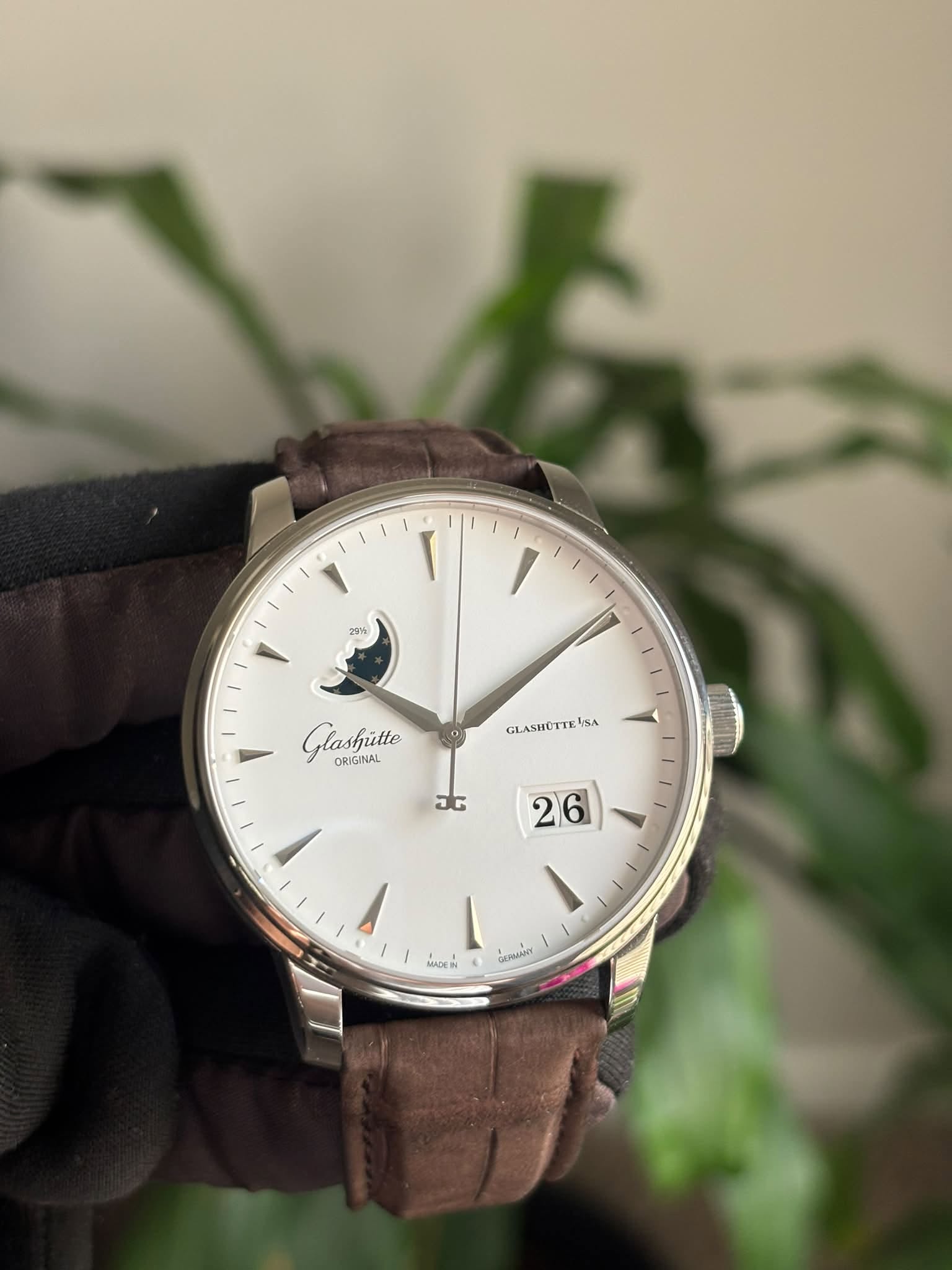 May be an image of leather, wrist watch and text
