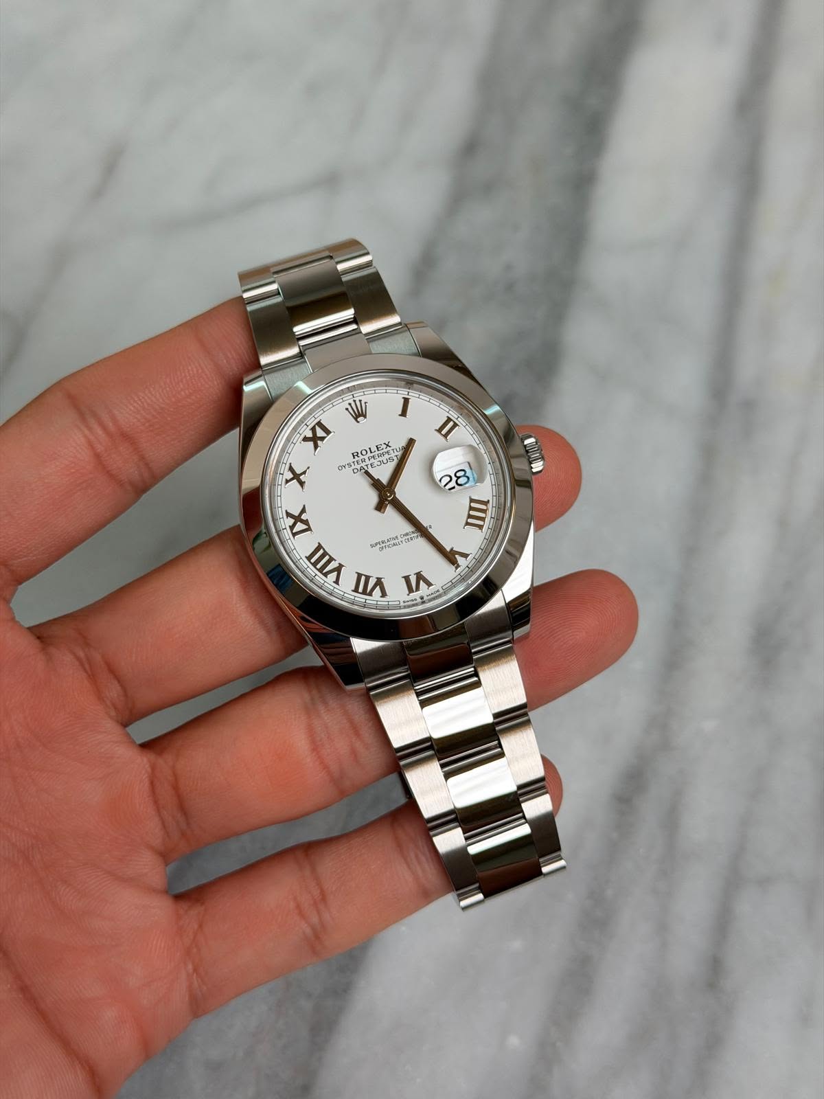May be an image of wrist watch and text