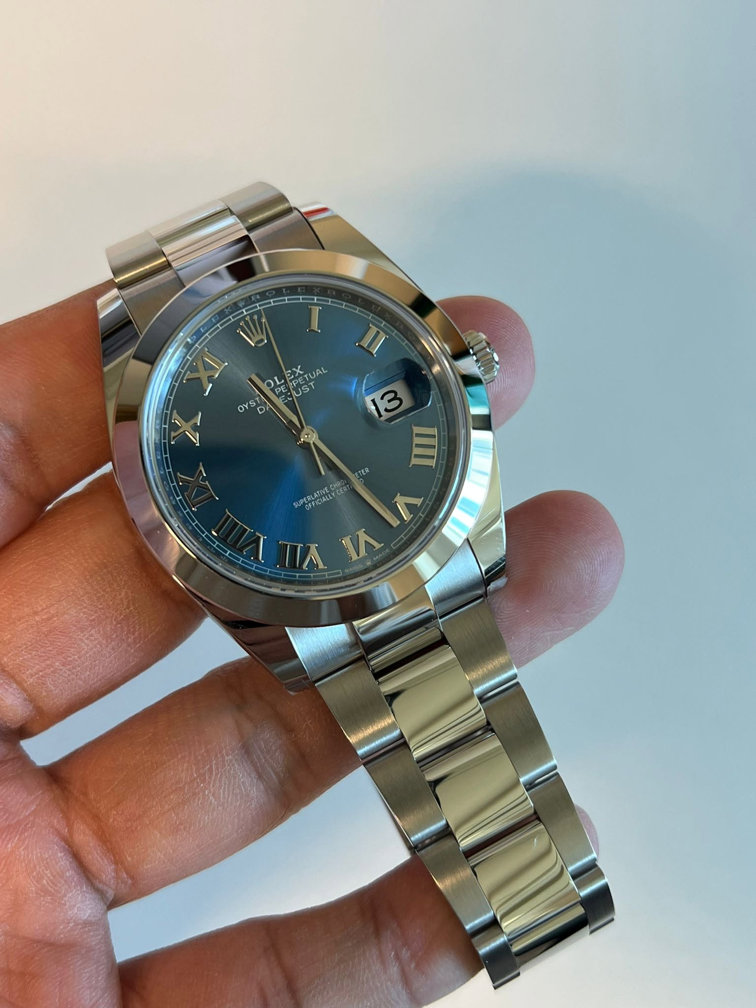 May be an image of wrist watch and text