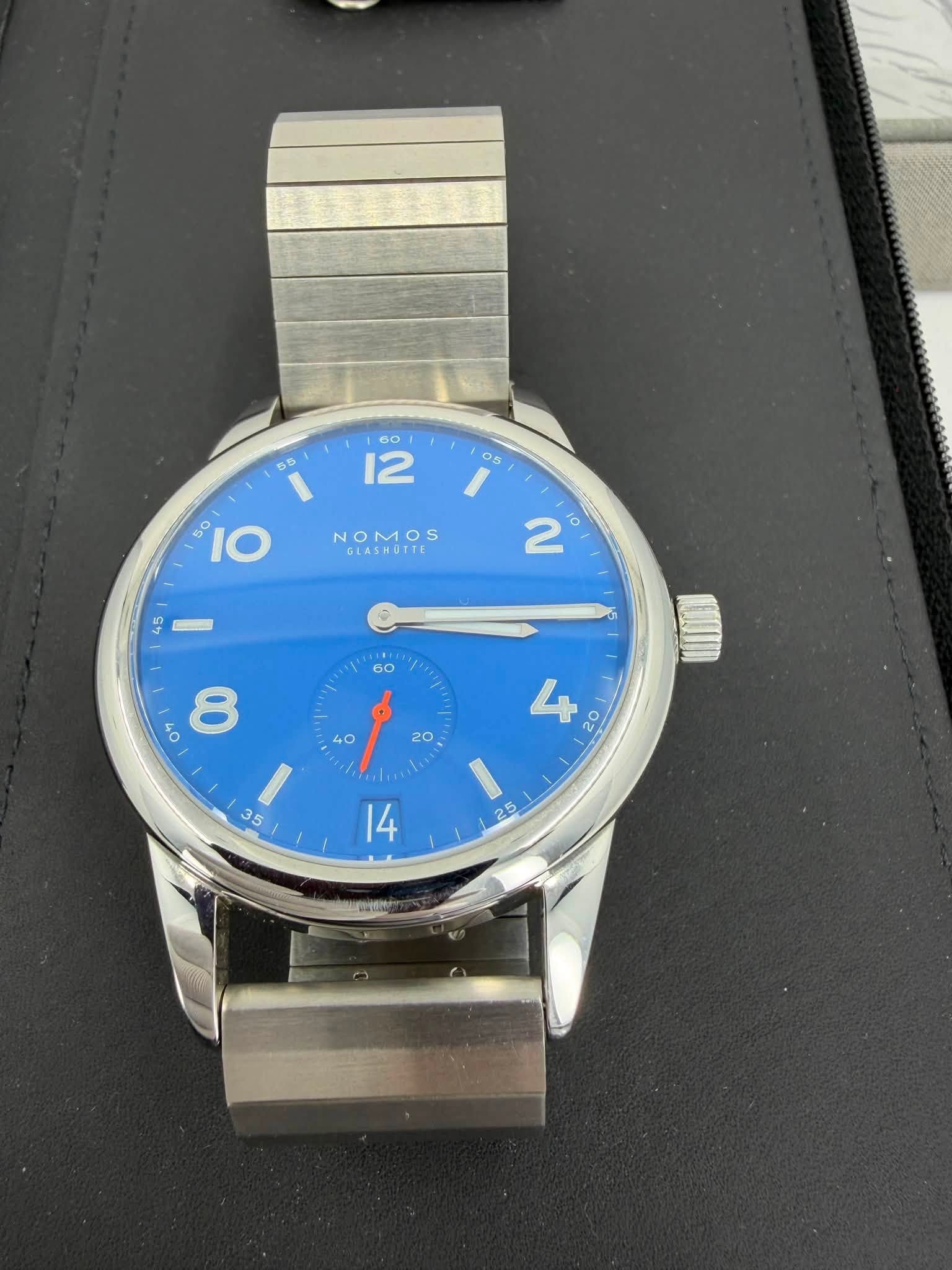 May be an image of wrist watch and text that says ' O NOMOS GLASHOTTE O" 8 ١ '
